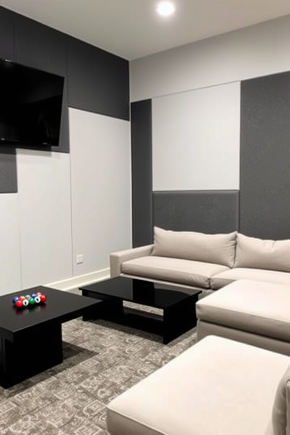 A contemporary game room featuring gray color blocks on the walls. The space is furnished with a plush sectional sofa and a sleek coffee table, creating a comfortable area for relaxation and entertainment.