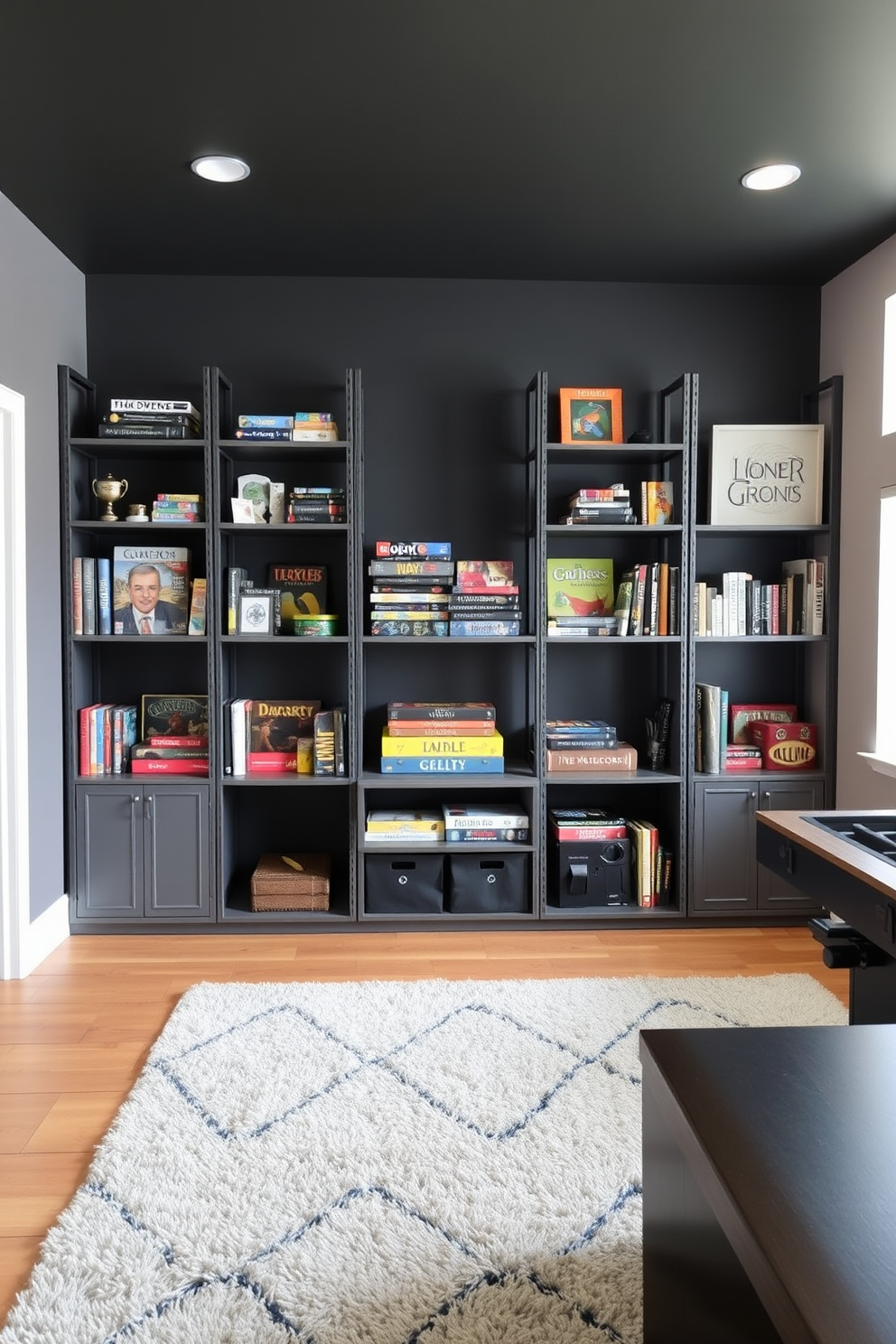 A modern game room featuring industrial style gray shelving units that showcase an array of board games and collectibles. The walls are painted in a deep charcoal hue, and the floor is adorned with a plush area rug in contrasting colors to create a cozy atmosphere.