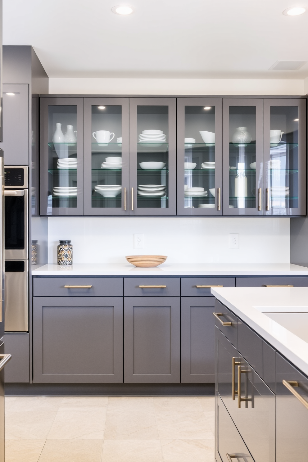 A modern kitchen featuring glossy gray cabinets with glass fronts that elegantly showcase dishware. The countertops are a sleek white quartz, complementing the contemporary aesthetic of the space.