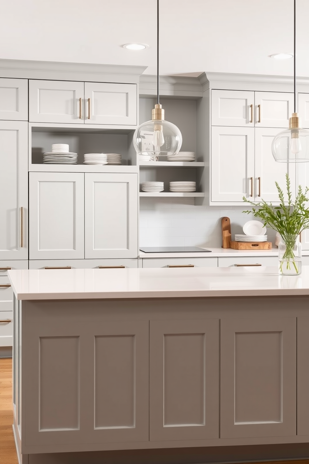 A modern kitchen featuring light gray cabinetry with sleek handles and open shelving displaying stylish dishware. The countertops are a polished white stone, complemented by minimalist pendant lighting hanging above the central island.