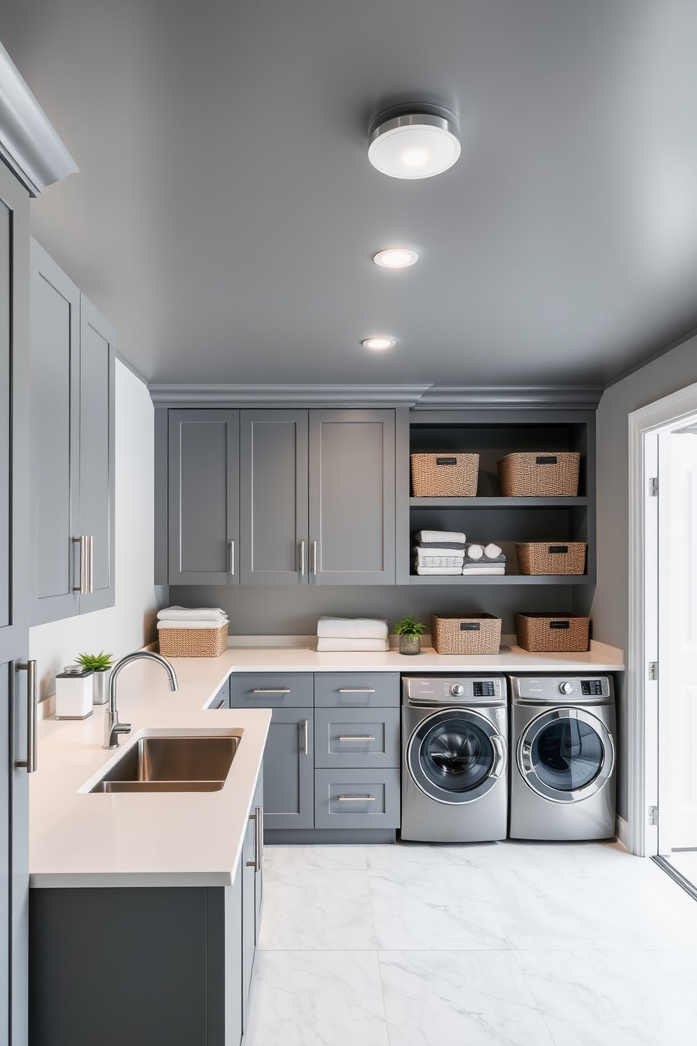 A modern laundry room featuring a gray painted ceiling that adds depth and sophistication. The space is designed with sleek gray cabinetry, a large stainless steel sink, and a countertop for folding clothes, complemented by stylish storage solutions.