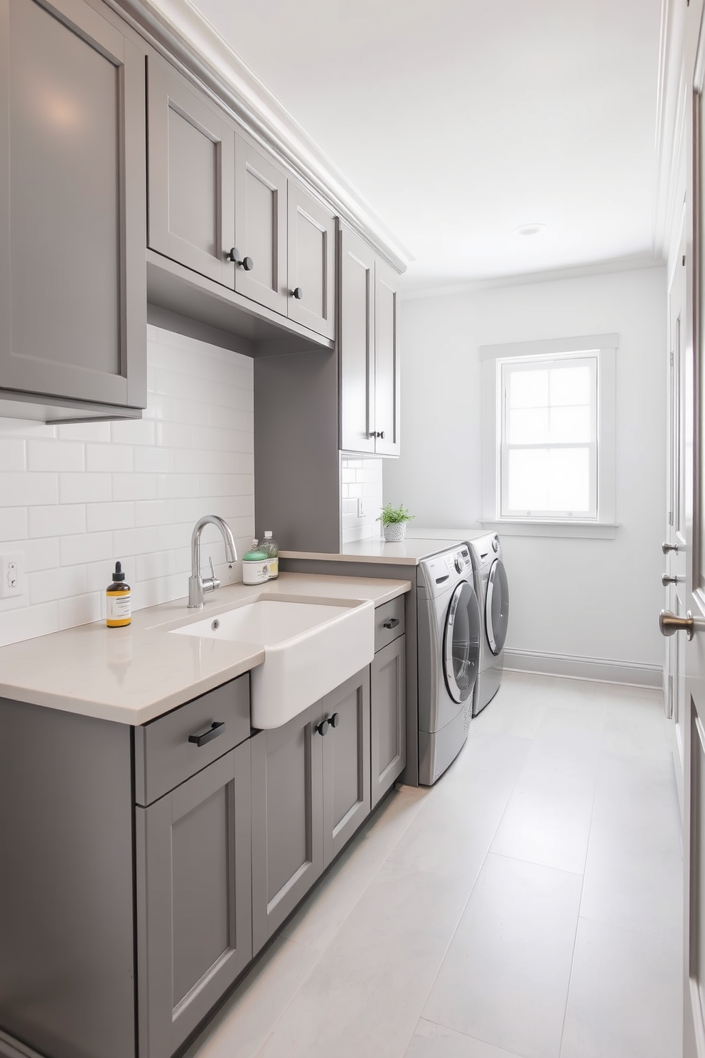 A modern laundry room featuring gray and white striped curtains that add a touch of softness to the space. The room includes sleek gray cabinets, a white countertop, and a stylish washer and dryer stacked for efficiency.