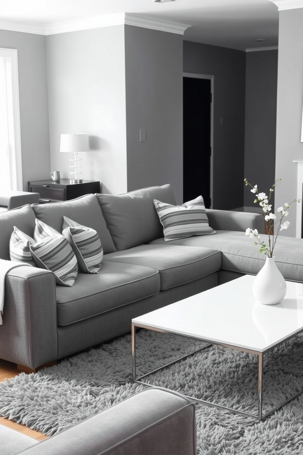 A cozy gray living room featuring wallpaper with subtle patterns that adds depth and texture to the space. The room is furnished with a plush gray sectional sofa, complemented by soft throw pillows and a stylish coffee table at the center. Natural light streams in through large windows, highlighting the elegant drapery that frames them. A modern area rug anchors the seating arrangement, while a few decorative accents bring warmth and personality to the overall design.