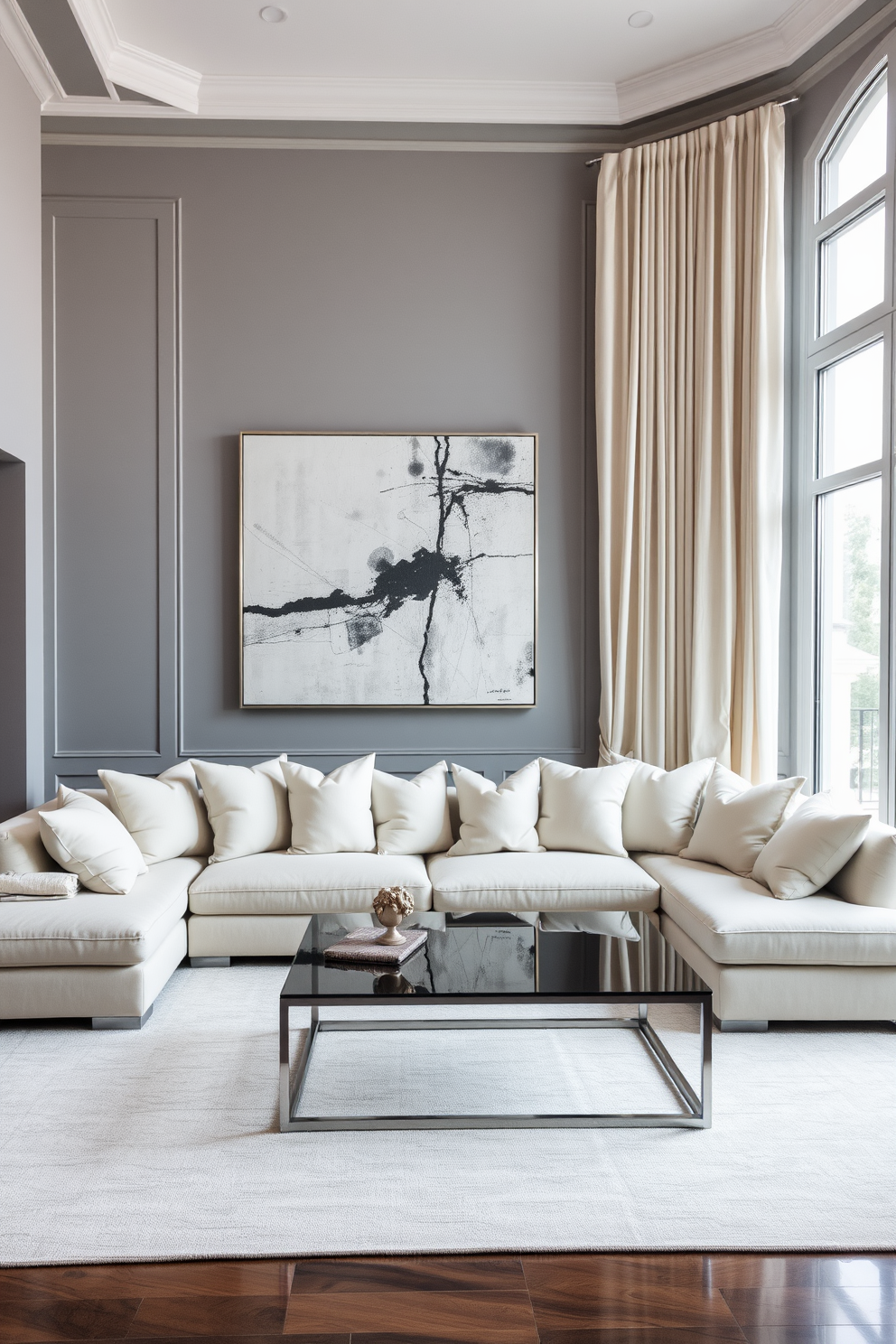 A timeless gray and cream living room featuring a plush sectional sofa adorned with cream throw pillows. The walls are painted in a soft gray hue, complemented by elegant cream curtains that cascade down from the ceiling. A sleek coffee table sits at the center, topped with a decorative tray and a few art books. A large piece of abstract artwork in shades of gray and cream hangs above the fireplace, creating a focal point in the room.