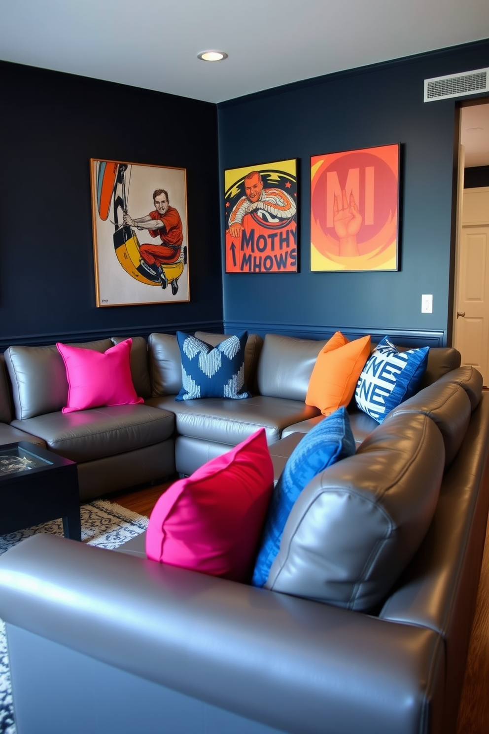 A spacious man cave featuring a gray leather sectional adorned with bold accent pillows in vibrant colors. The walls are painted a deep navy blue, and the floor is a rich hardwood, creating a cozy yet modern atmosphere.