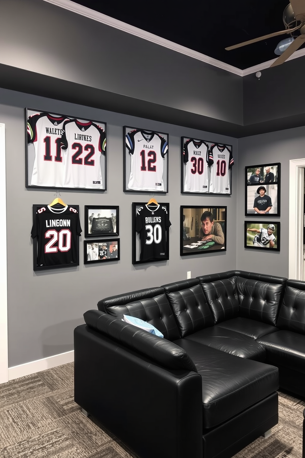 A stylish man cave featuring a gray and black sports memorabilia display. The walls are adorned with framed jerseys and signed photographs, while a sleek black leather sectional sofa provides comfortable seating.