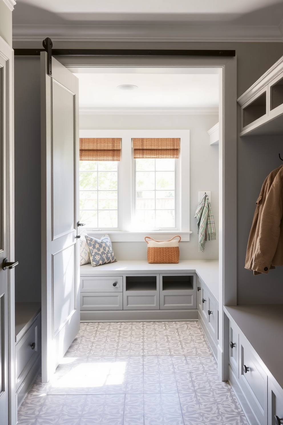 A stylish gray mudroom features built-in shoe storage with sleek cabinetry and ample space for organization. The walls are painted in a soft gray hue, complemented by a durable tile floor in a contrasting darker shade.