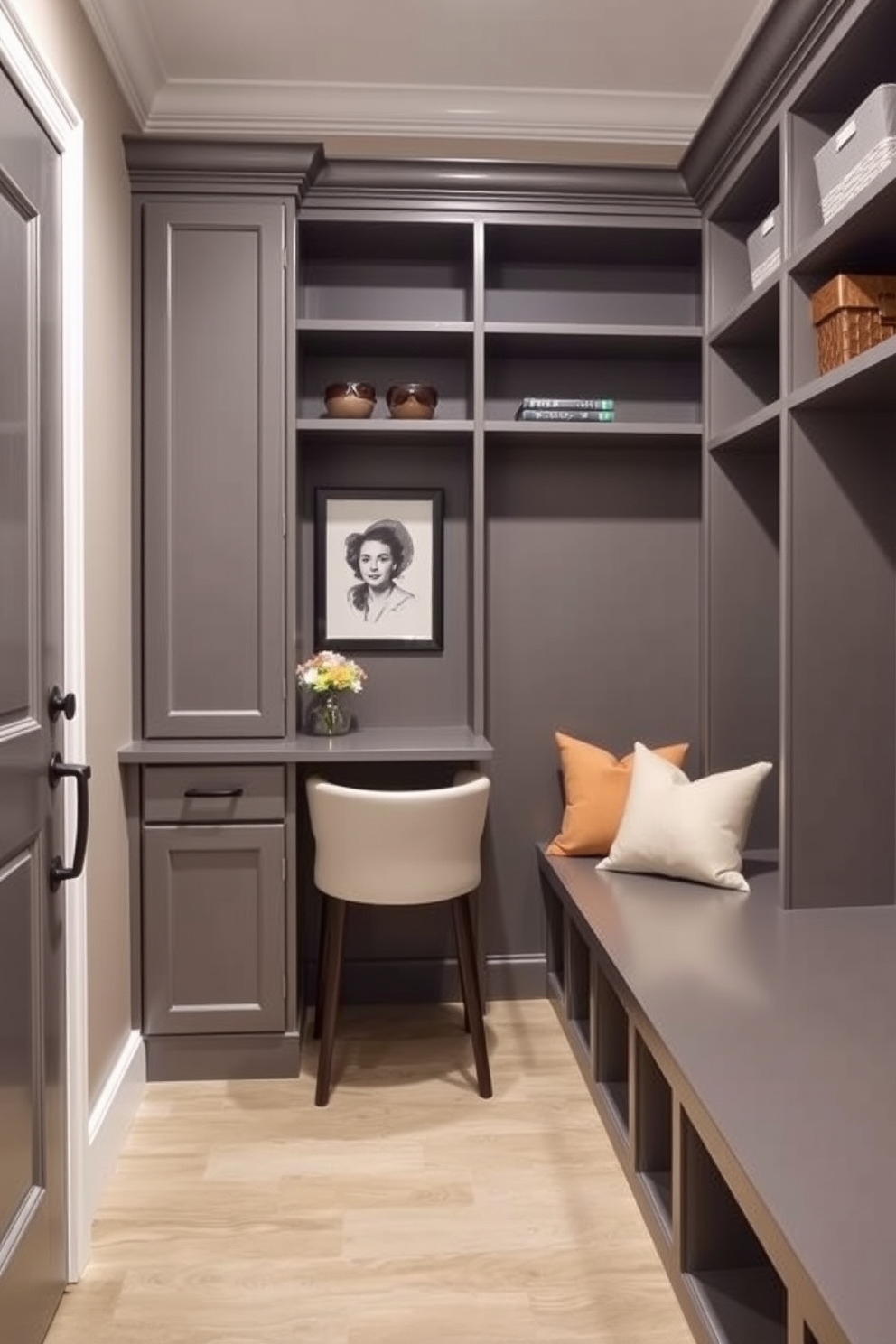 A stylish mudroom features a small desk area with a sleek gray finish. The walls are adorned with built-in shelving for storage and a comfortable bench with soft cushions.