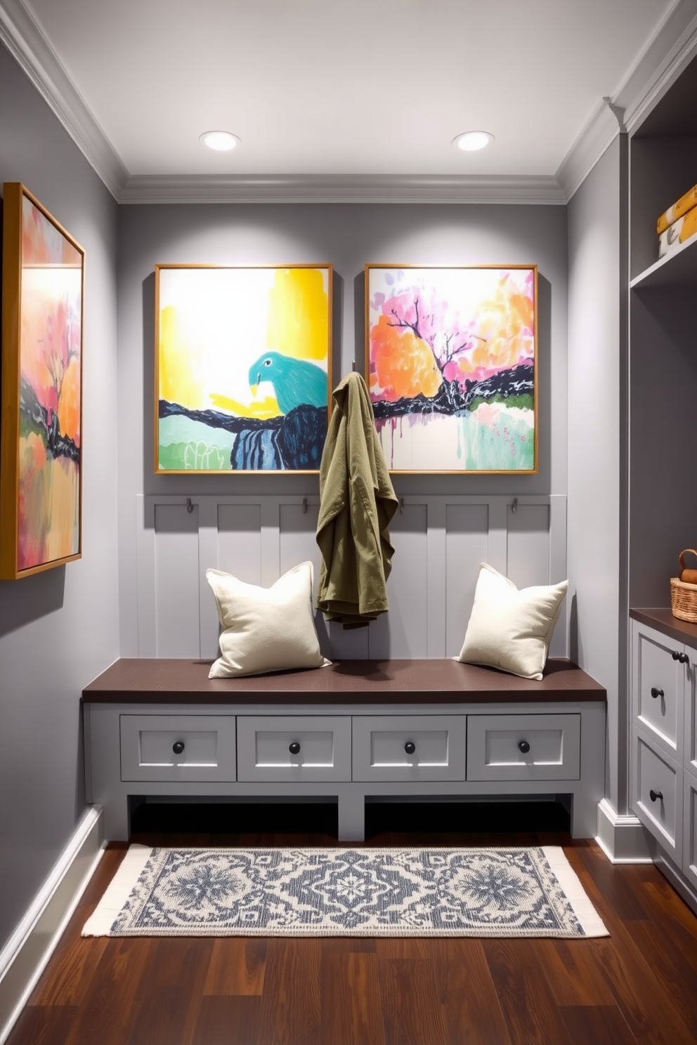 Bright artwork to contrast gray tones. The walls are painted in a soft gray, creating a neutral backdrop for vibrant, colorful paintings that add energy and personality to the space. Gray mudroom design ideas feature a functional layout with built-in storage solutions. Incorporate a bench with plush cushions, hooks for coats, and a stylish rug to enhance both comfort and style.