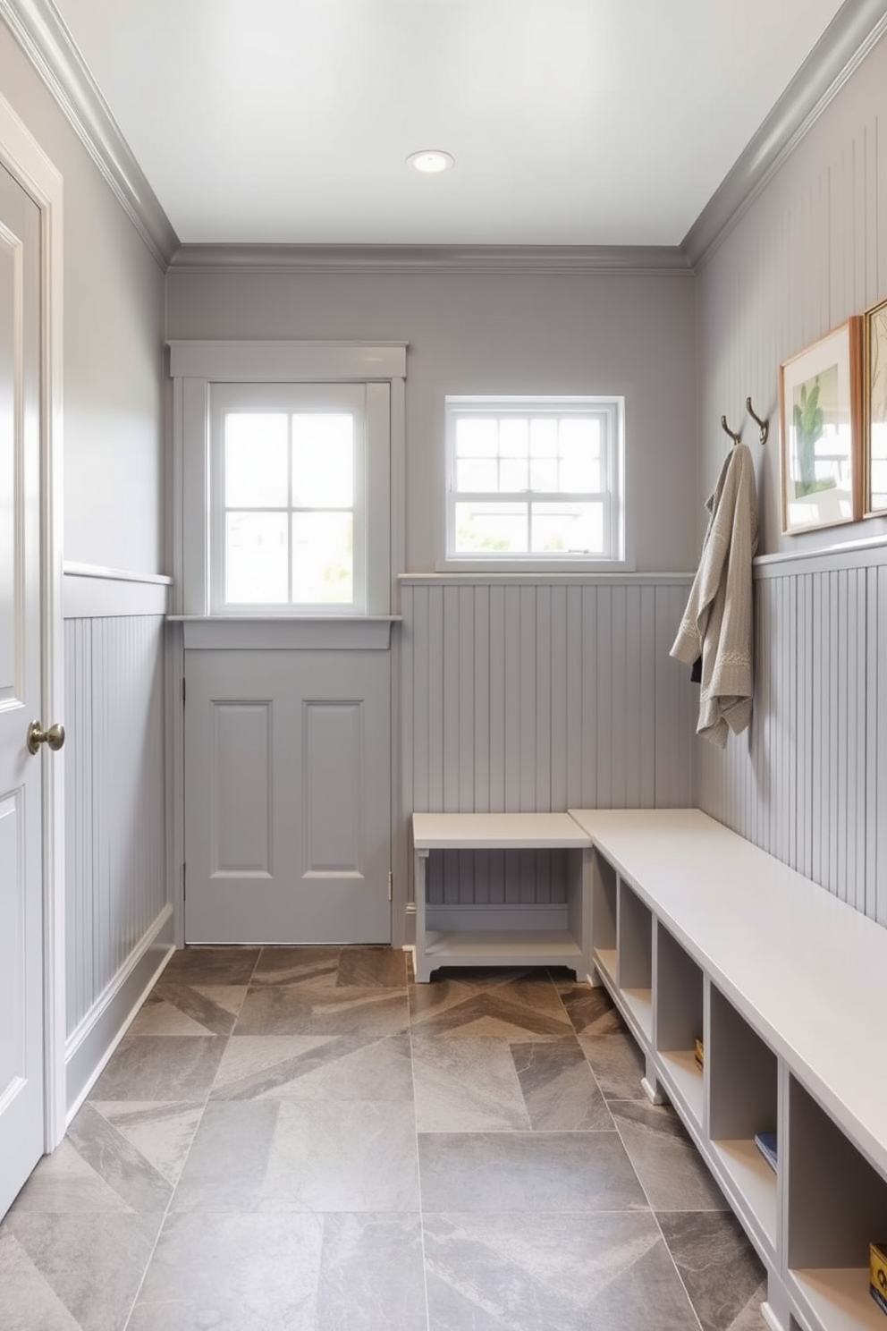 A cozy mudroom design featuring soft gray curtains that gently frame a large window. The walls are painted in a light gray shade, complemented by a built-in bench with plush cushions and storage cubbies underneath.