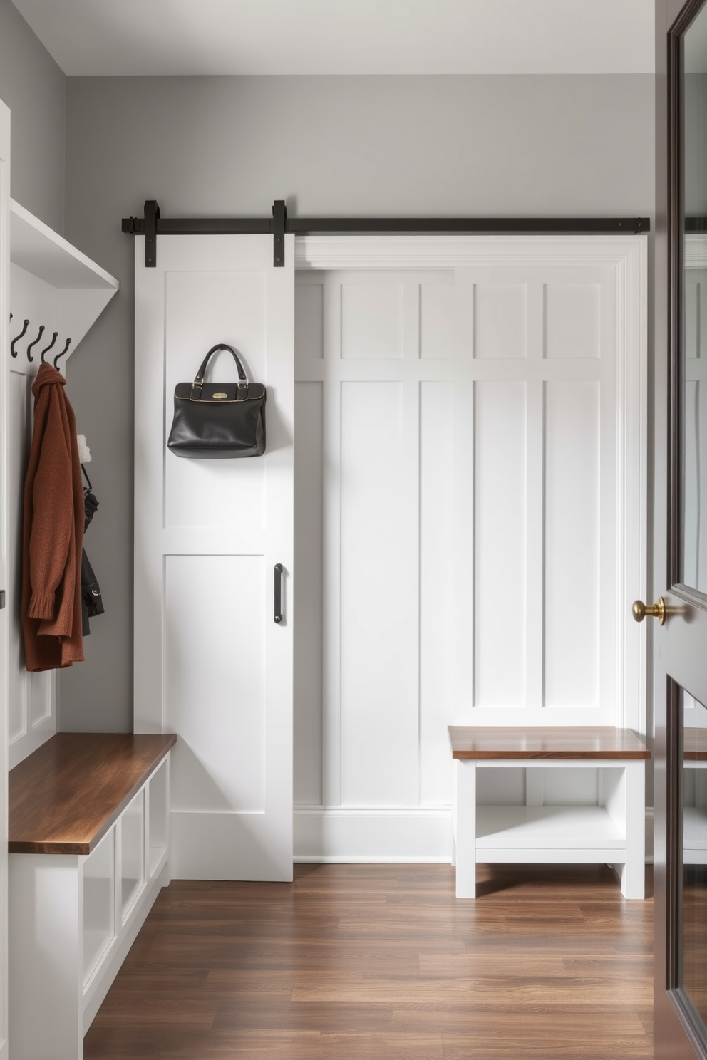 A contemporary mudroom featuring sliding doors that maximize space efficiency. The walls are painted in a soft gray, complemented by built-in storage benches and hooks for coats and bags.