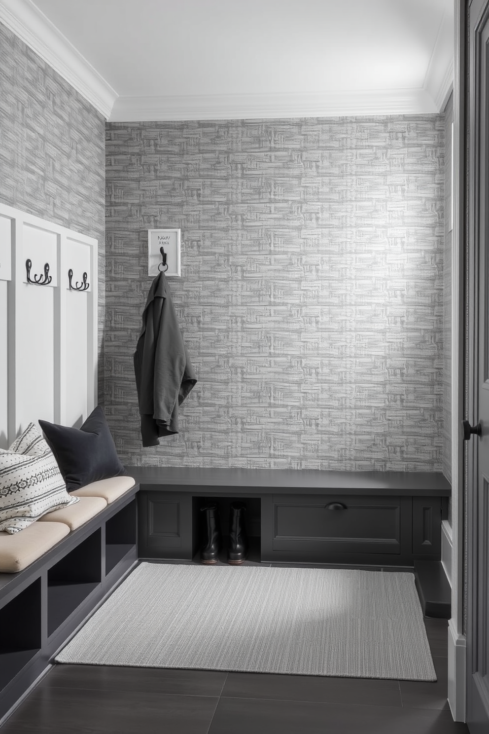 A stylish gray mudroom features textured gray wallpaper that adds depth and interest to the space. The room includes built-in benches with plush cushions and hooks for hanging coats, creating a functional yet elegant entryway.