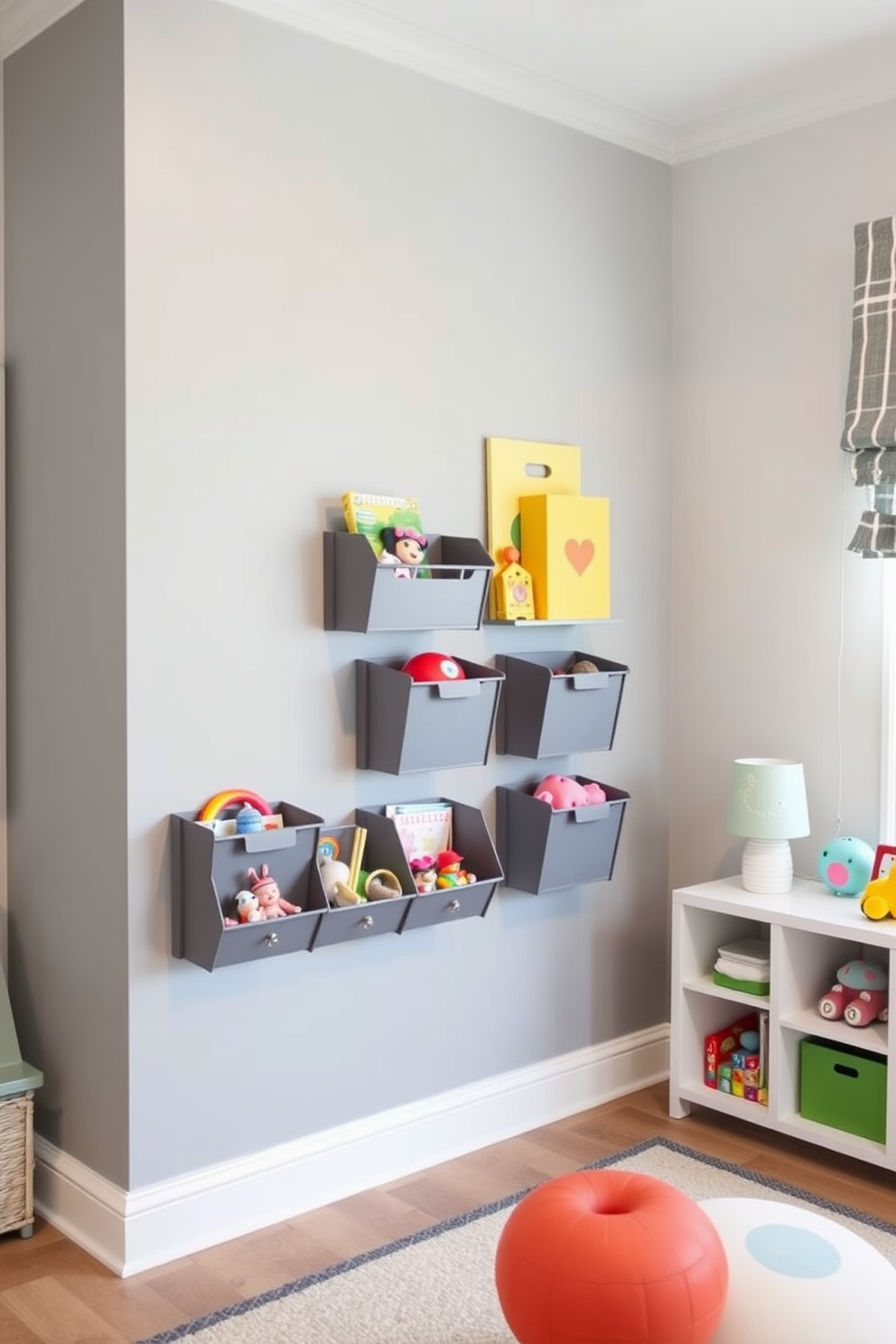 A playful and modern playroom featuring wall-mounted gray storage units designed for organizing small toys. The walls are painted in a soft gray hue, complemented by colorful accents in the decor and furnishings to create an inviting atmosphere.