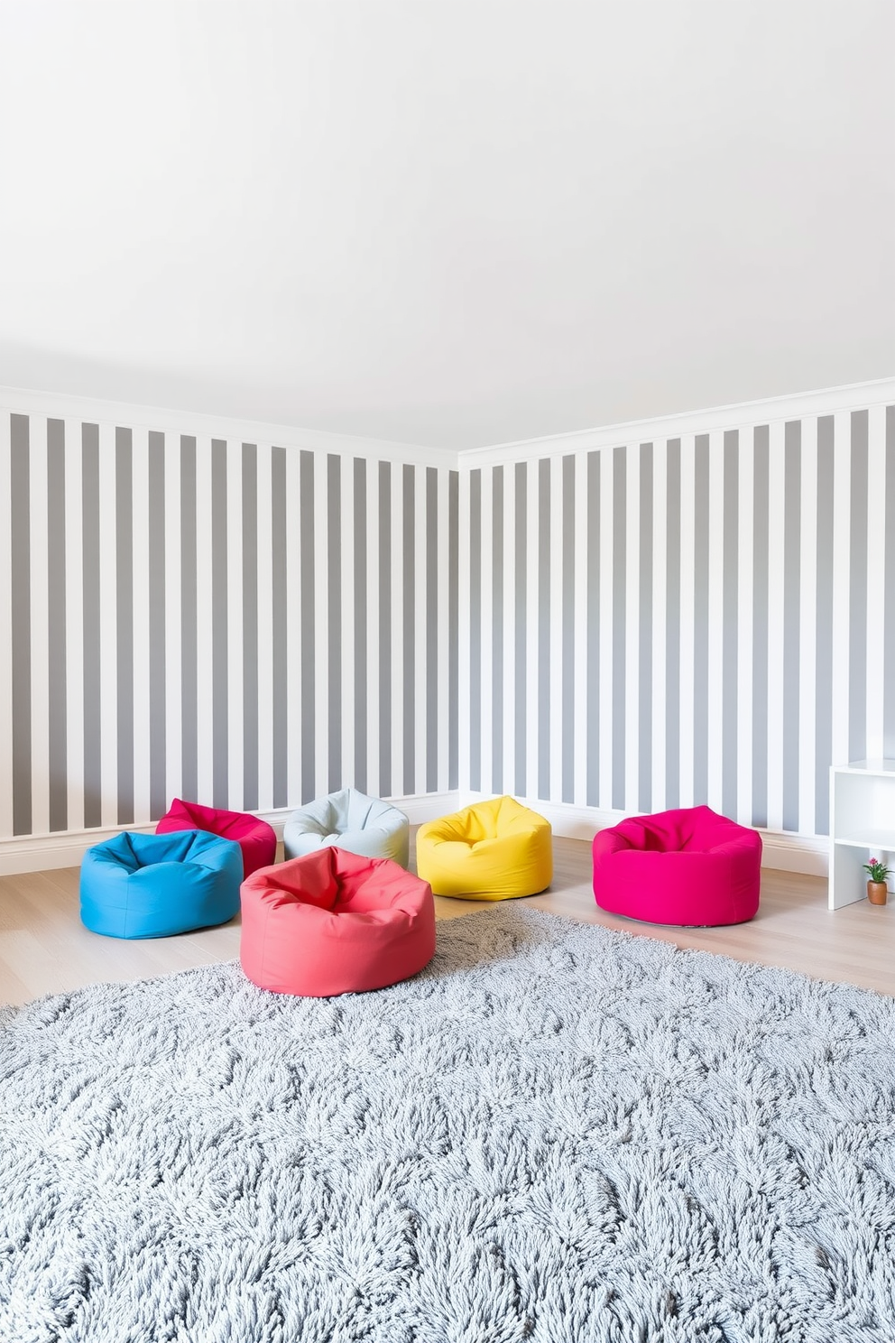 A playful gray and white striped wallpaper adorns the walls of a vibrant playroom. The ceiling is painted in a soft white, creating a bright and airy atmosphere. Colorful bean bags are scattered across the floor, inviting children to sit and play. A large, plush rug in shades of gray adds comfort and warmth to the space.