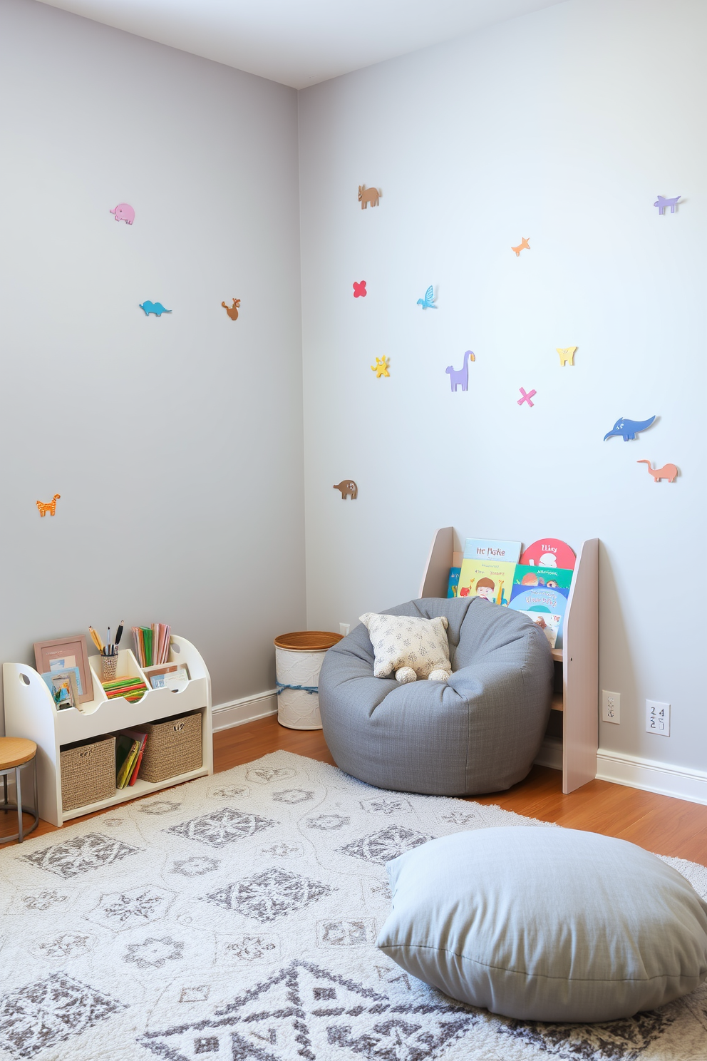 A playful gray playroom featuring whimsical wall decals that add a touch of fun to the space. The walls are painted in a soft gray shade, creating a calm backdrop for colorful decals of animals and shapes. A cozy reading nook is set up in one corner with a plush gray bean bag and a small bookshelf filled with children's books. The floor is covered in a soft area rug that complements the gray theme while providing a comfortable play area for kids.