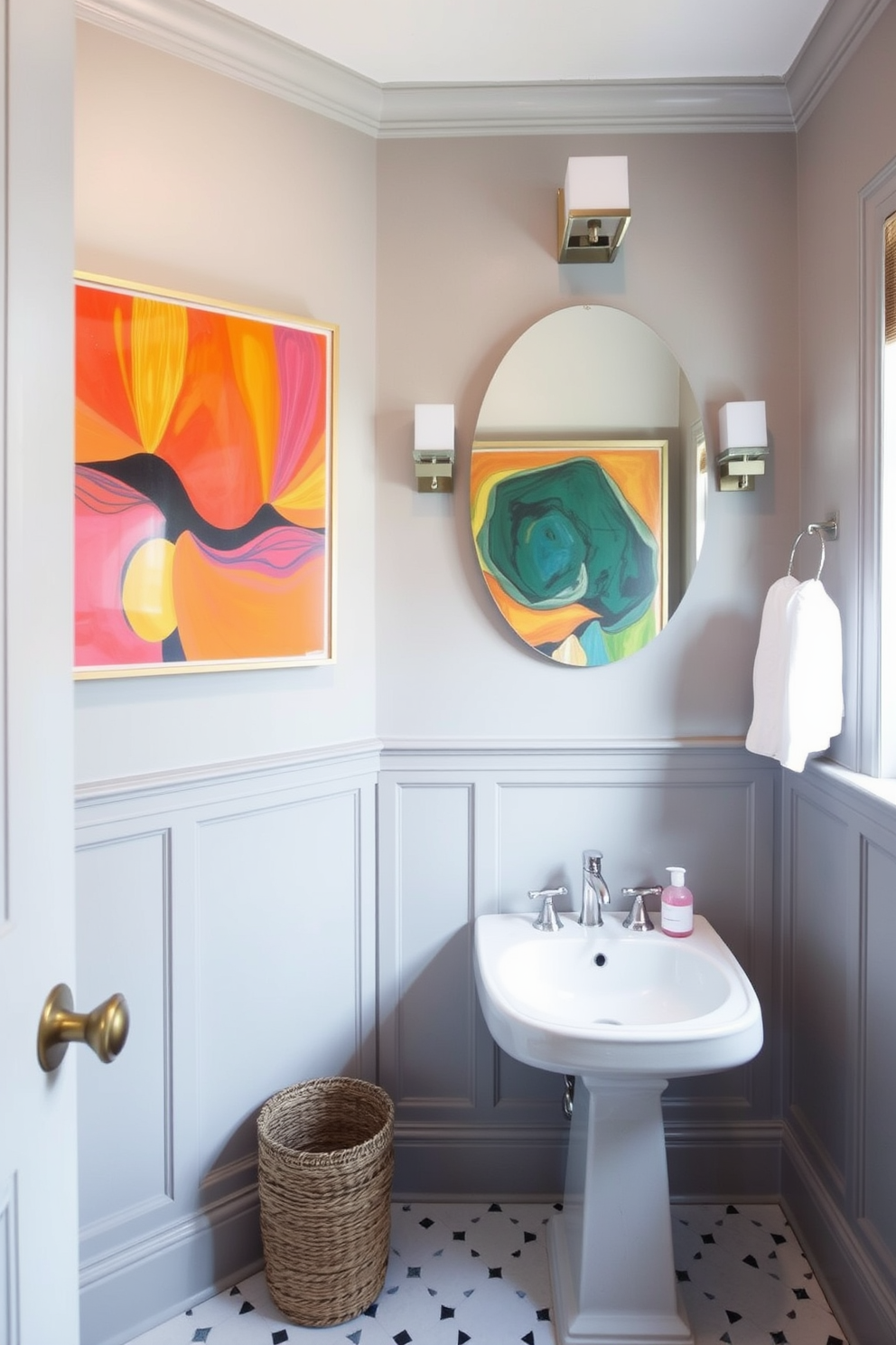 A stylish powder room featuring muted gray tones on the walls and fixtures creates a serene atmosphere. Bright, colorful artwork is displayed prominently on the walls, adding a vibrant contrast to the space.