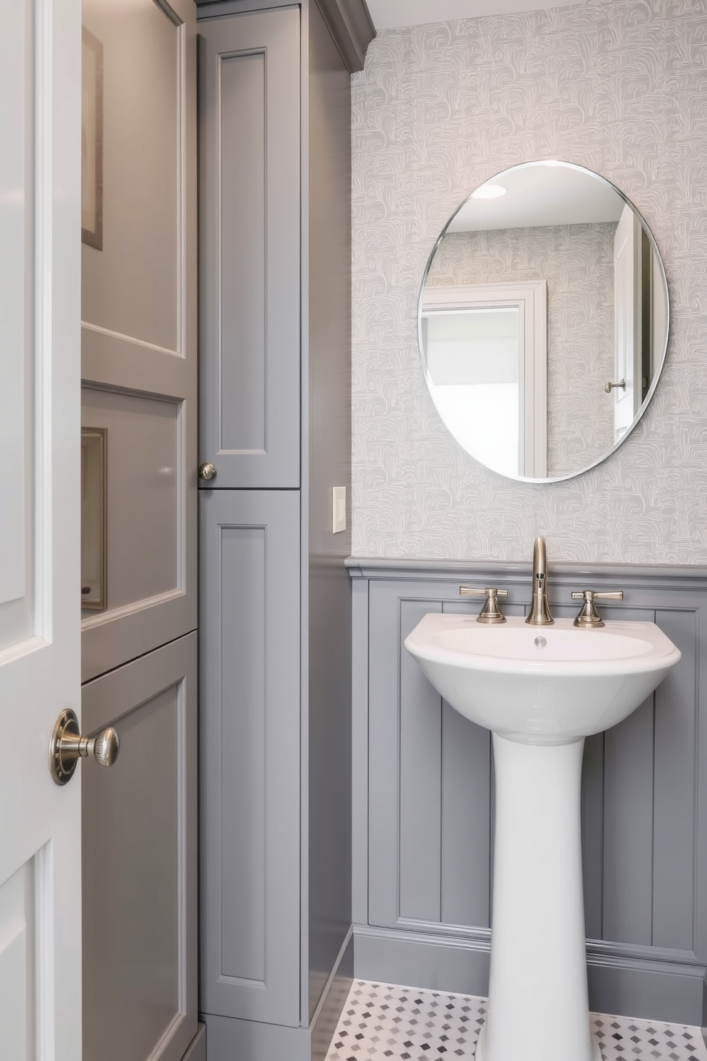 A chic gray powder room featuring a stunning gray mosaic backsplash behind the sink. The space is enhanced by sleek fixtures and elegant lighting that create a warm and inviting atmosphere.