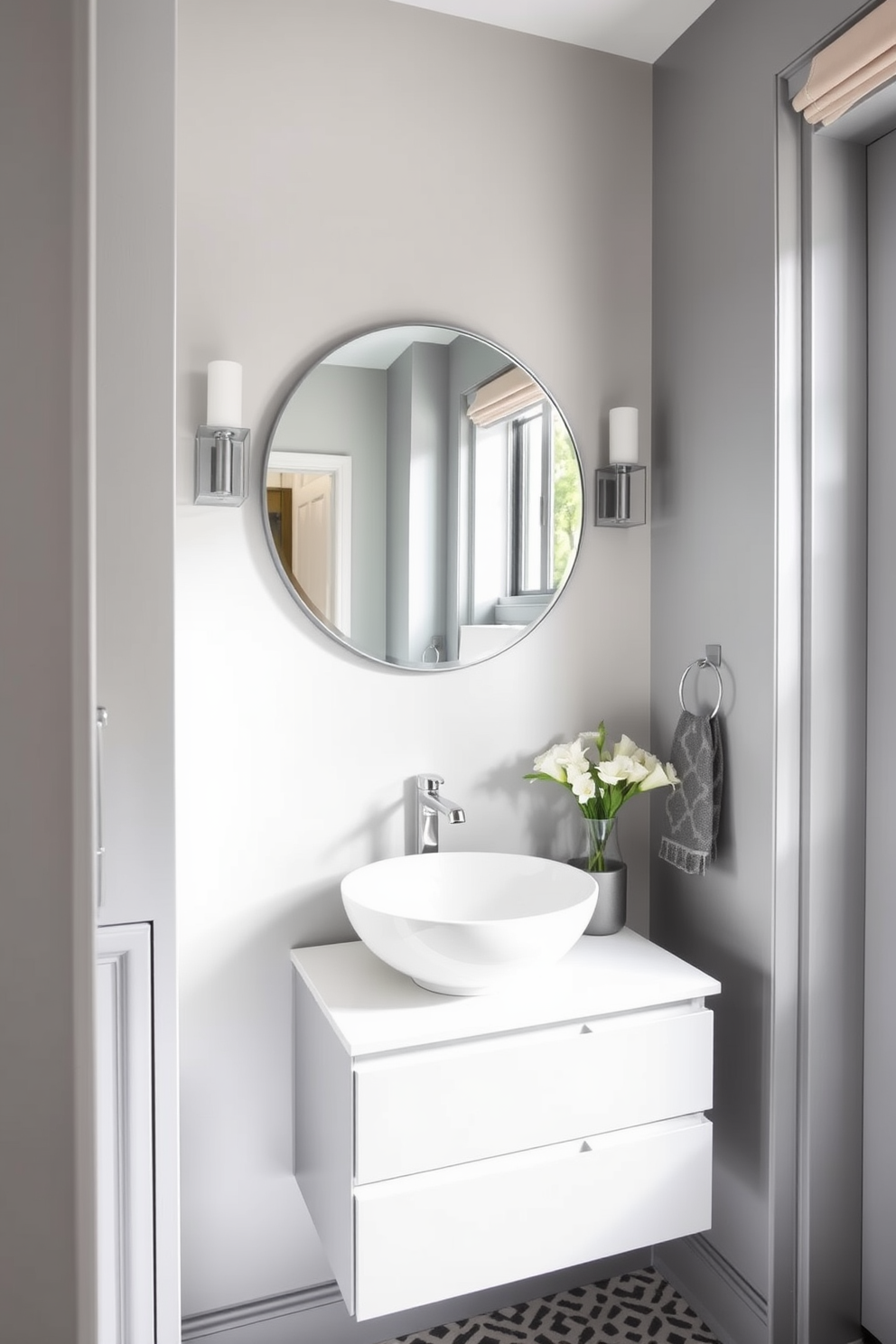 Chic gray accessories and towels enhance the elegance of a modern powder room. The walls are painted in a soft gray hue, complemented by a sleek gray vanity with polished chrome fixtures. Stylish gray towels are neatly arranged on a decorative shelf, adding a touch of sophistication. A round mirror with a minimalist frame reflects the subtle beauty of the space, creating a serene atmosphere.