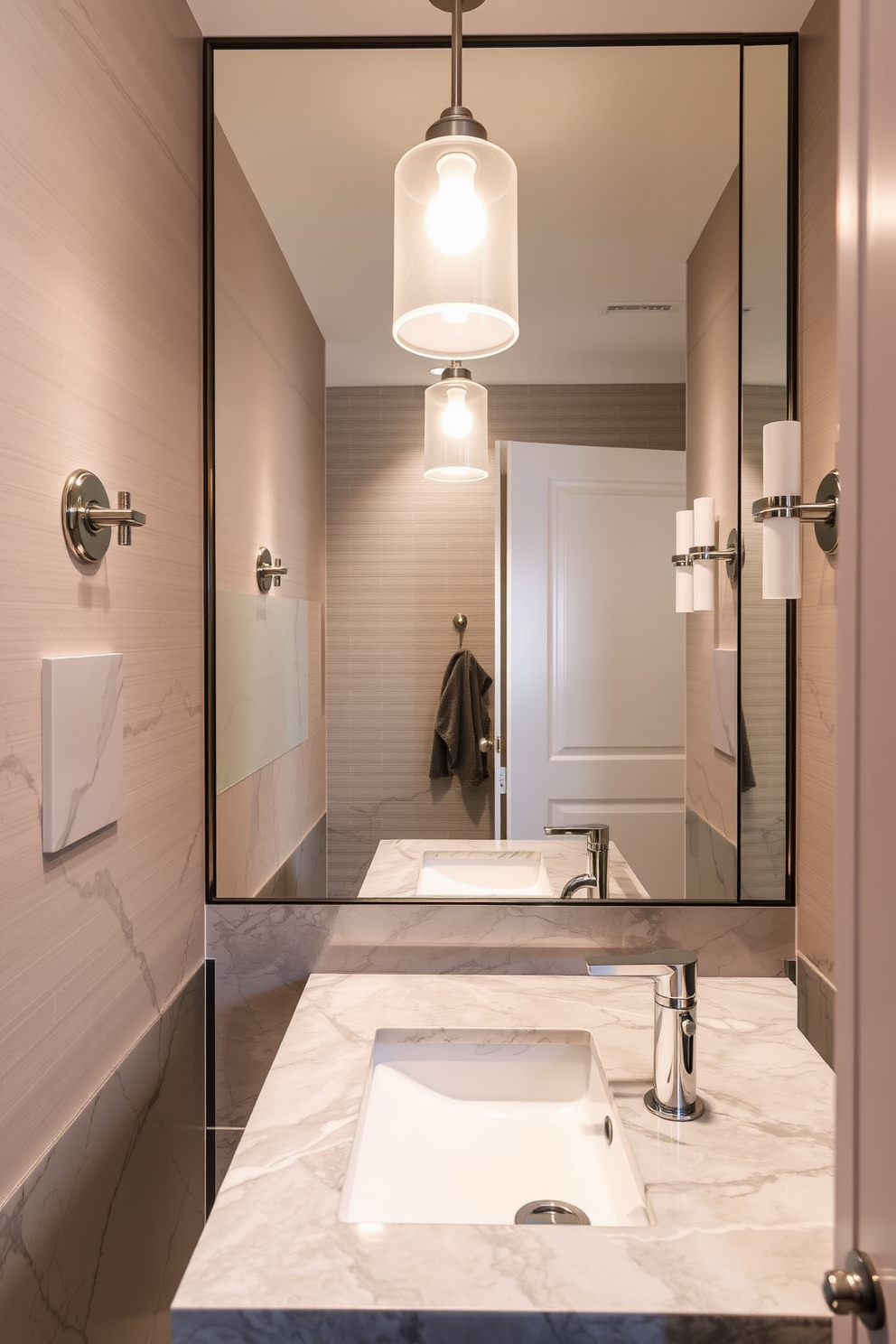 A chic gray and white powder room featuring a striking color block design. The walls are painted in alternating sections of soft gray and crisp white, creating a modern and fresh atmosphere. A sleek pedestal sink with a minimalist faucet is centered against the wall. Above the sink, a large round mirror with a thin black frame enhances the sense of space and light.