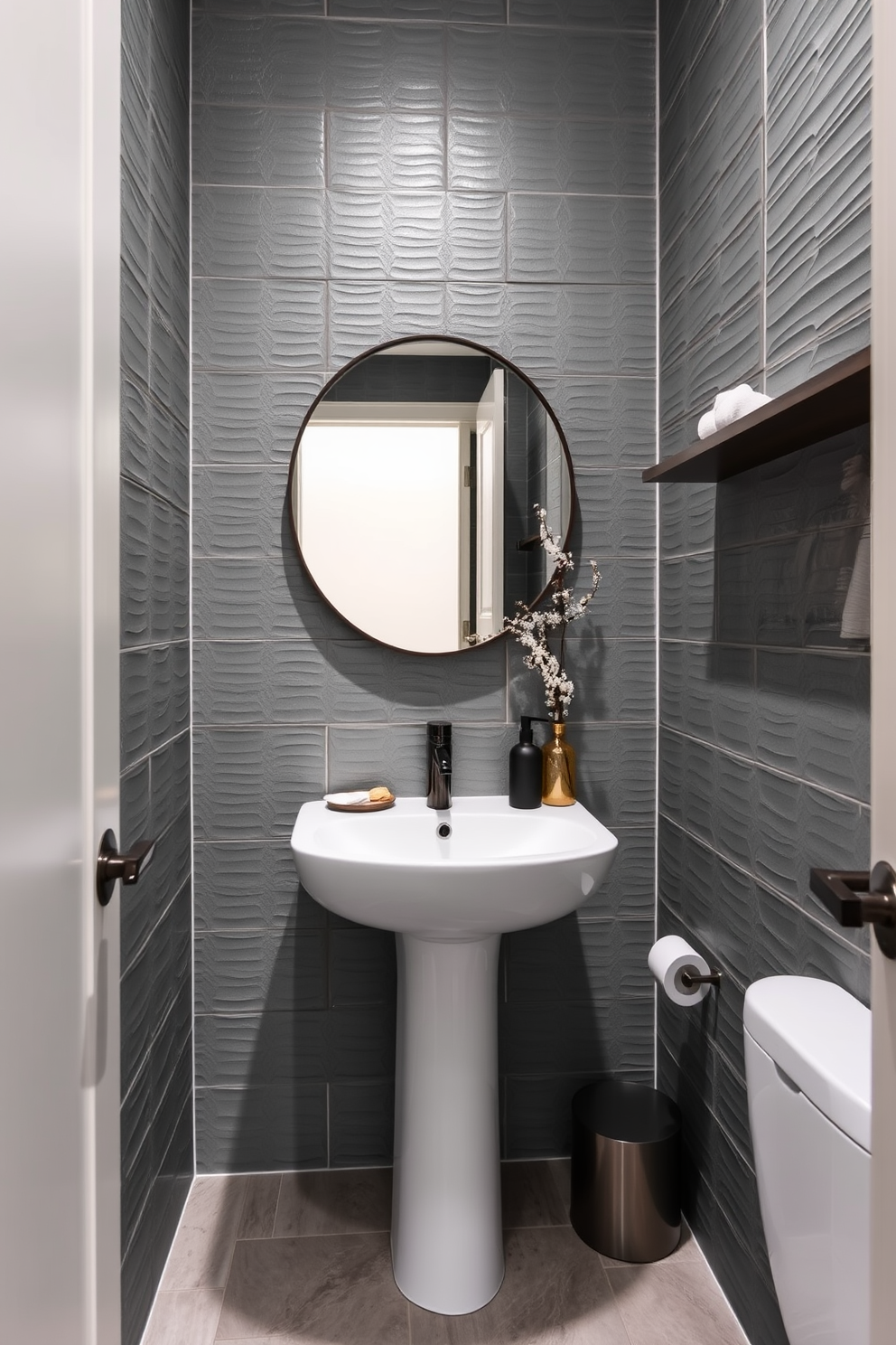 Textured gray tiles create a modern ambiance in the powder room. The space features sleek fixtures and minimalist decor that complement the contemporary design.