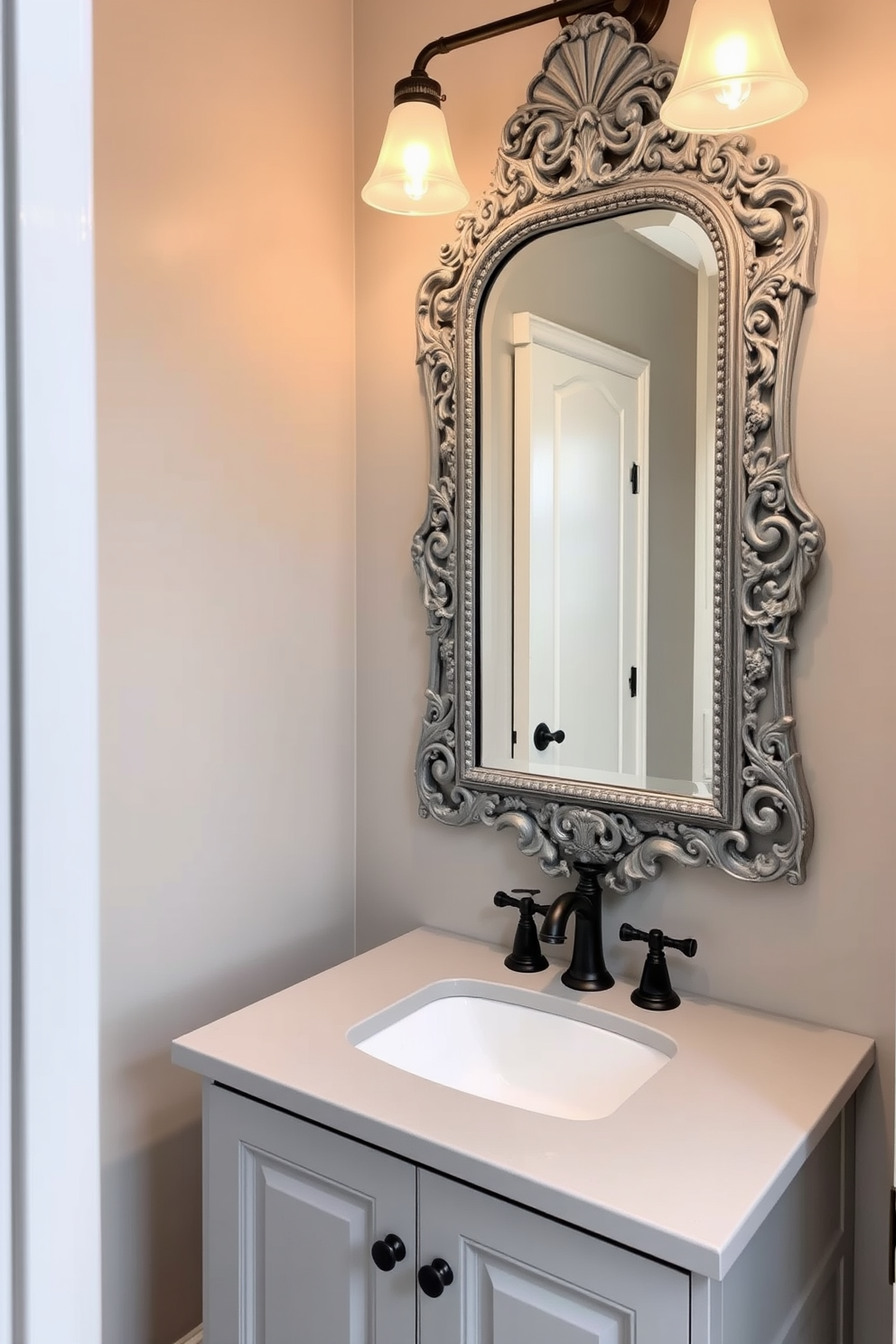 A vintage gray mirror with an ornate frame hangs above a sleek gray vanity. The powder room features soft lighting that highlights the intricate details of the mirror and complements the elegant gray color scheme.