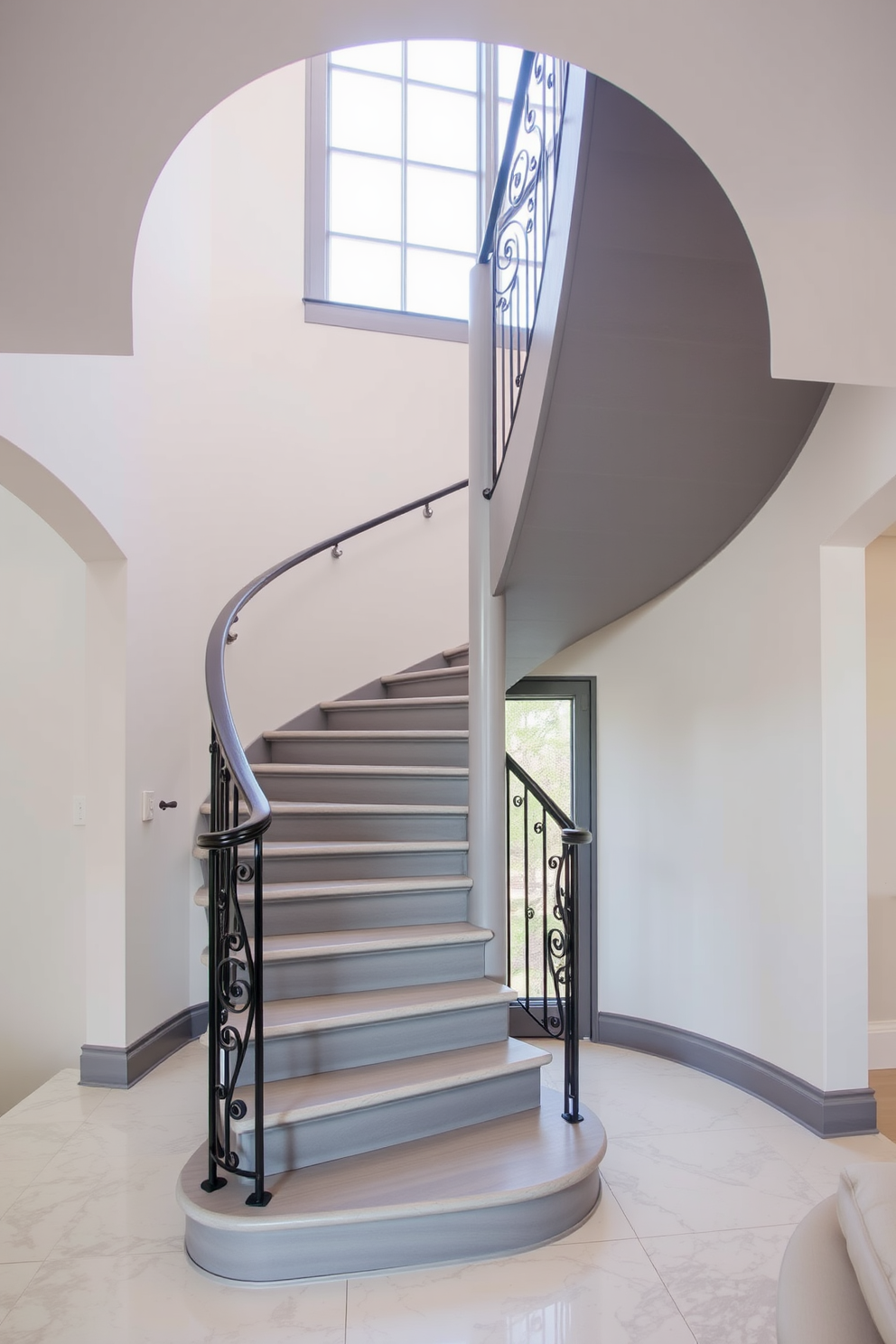 A stunning spiral gray staircase gracefully ascends, featuring an elegant wrought iron railing that adds a touch of sophistication. The staircase is surrounded by light-colored walls that enhance its modern aesthetic, creating a striking focal point in the entryway.