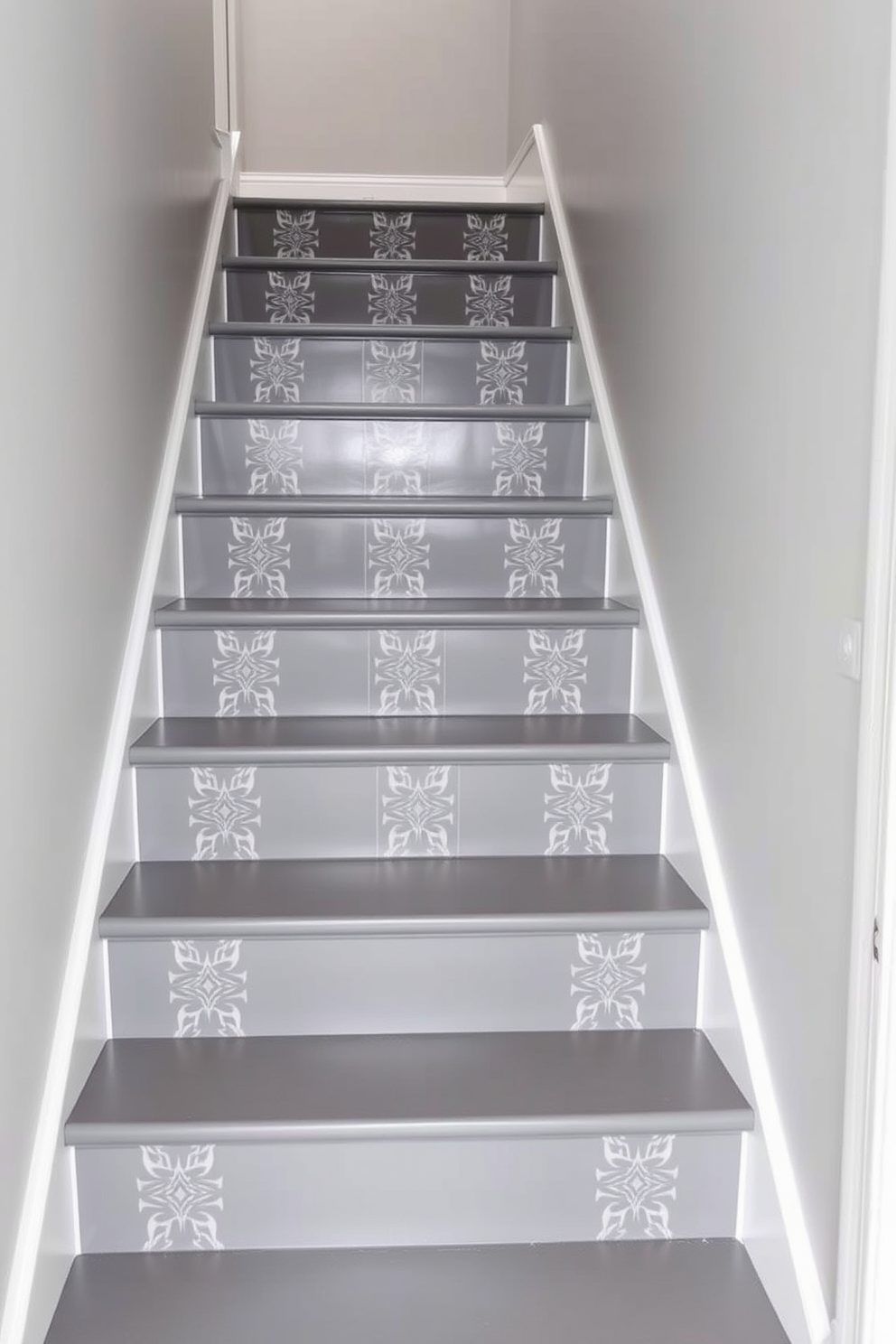 Chic gray stairs adorned with elegant patterned wallpaper create a stunning focal point in the entryway. The staircase features sleek gray treads and risers, complemented by a stylish handrail that enhances the overall design.