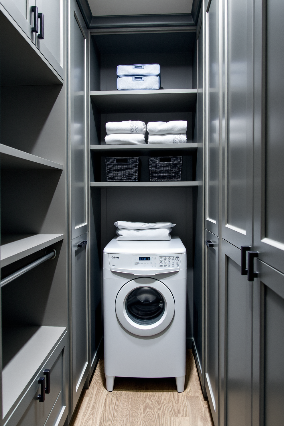 A minimalist walk-in closet featuring clean lines and an open layout. The walls are painted in a soft white, complemented by sleek gray cabinetry and a simple island in the center for accessories.