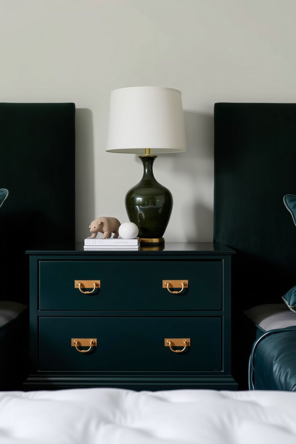 A serene bedroom setting featuring dark green nightstands adorned with elegant brass hardware. The walls are painted in a soft, complementary shade, creating a tranquil atmosphere for relaxation.