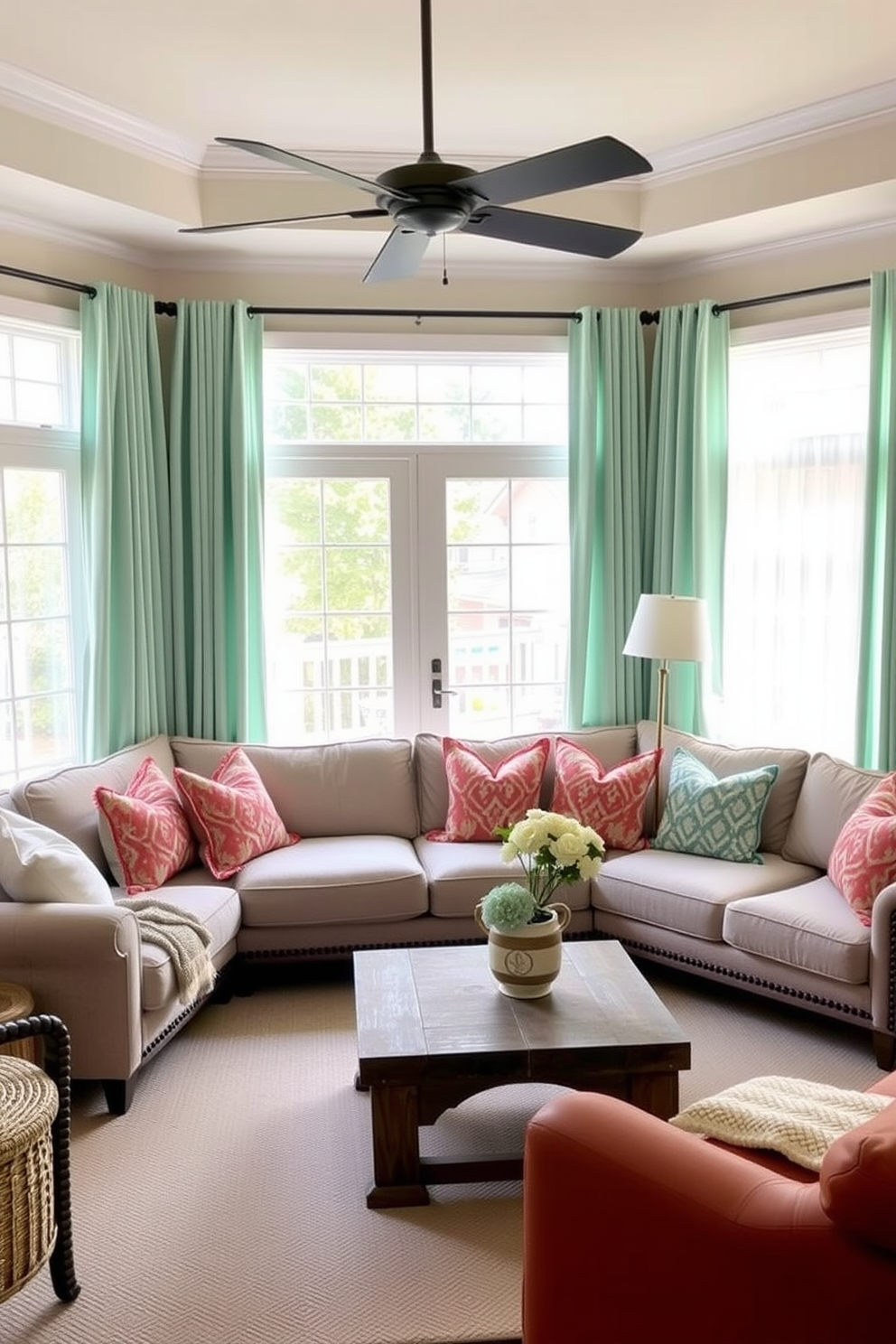 A cozy family room features a light green rug laid over warm hardwood floors. The space is adorned with plush seating in neutral tones, complemented by decorative cushions that add a touch of color.