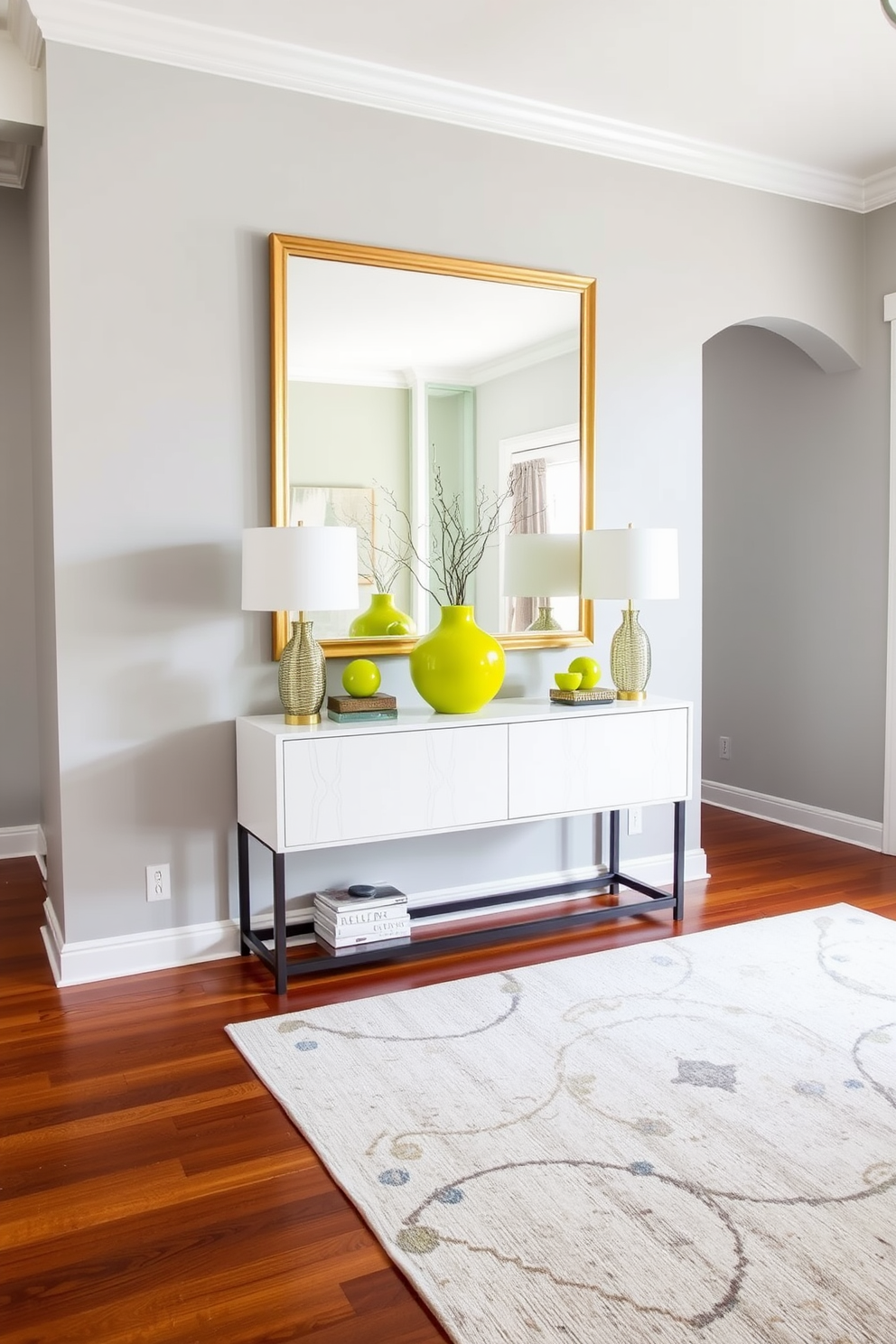 A welcoming foyer with a soft gray backdrop that enhances the brightness of chartreuse accessories. The space features a sleek console table adorned with a vibrant chartreuse vase and matching decorative items, creating a striking focal point. The flooring is a rich hardwood that adds warmth to the design, while a large area rug in neutral tones anchors the space. A stylish mirror with a gold frame hangs above the console, reflecting the lively colors and inviting natural light into the foyer.