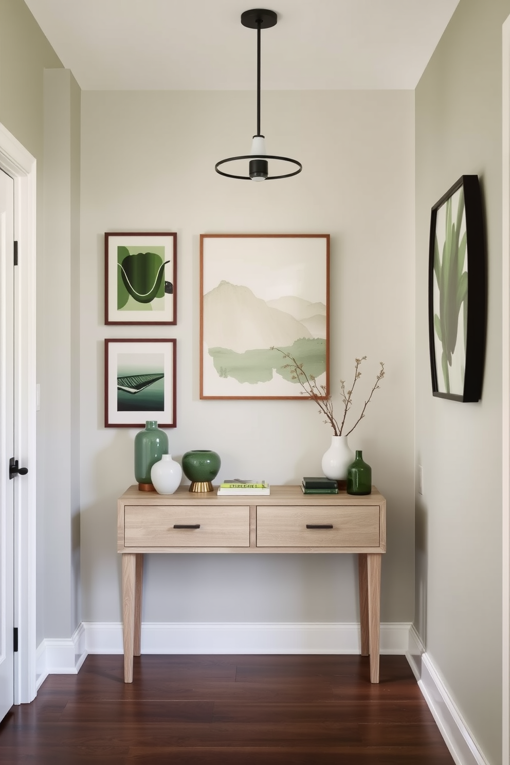 A welcoming foyer adorned with sage green floral wallpaper border that adds a touch of elegance. The space features a classic console table with a decorative mirror above it, complemented by a stylish pendant light hanging from the ceiling.