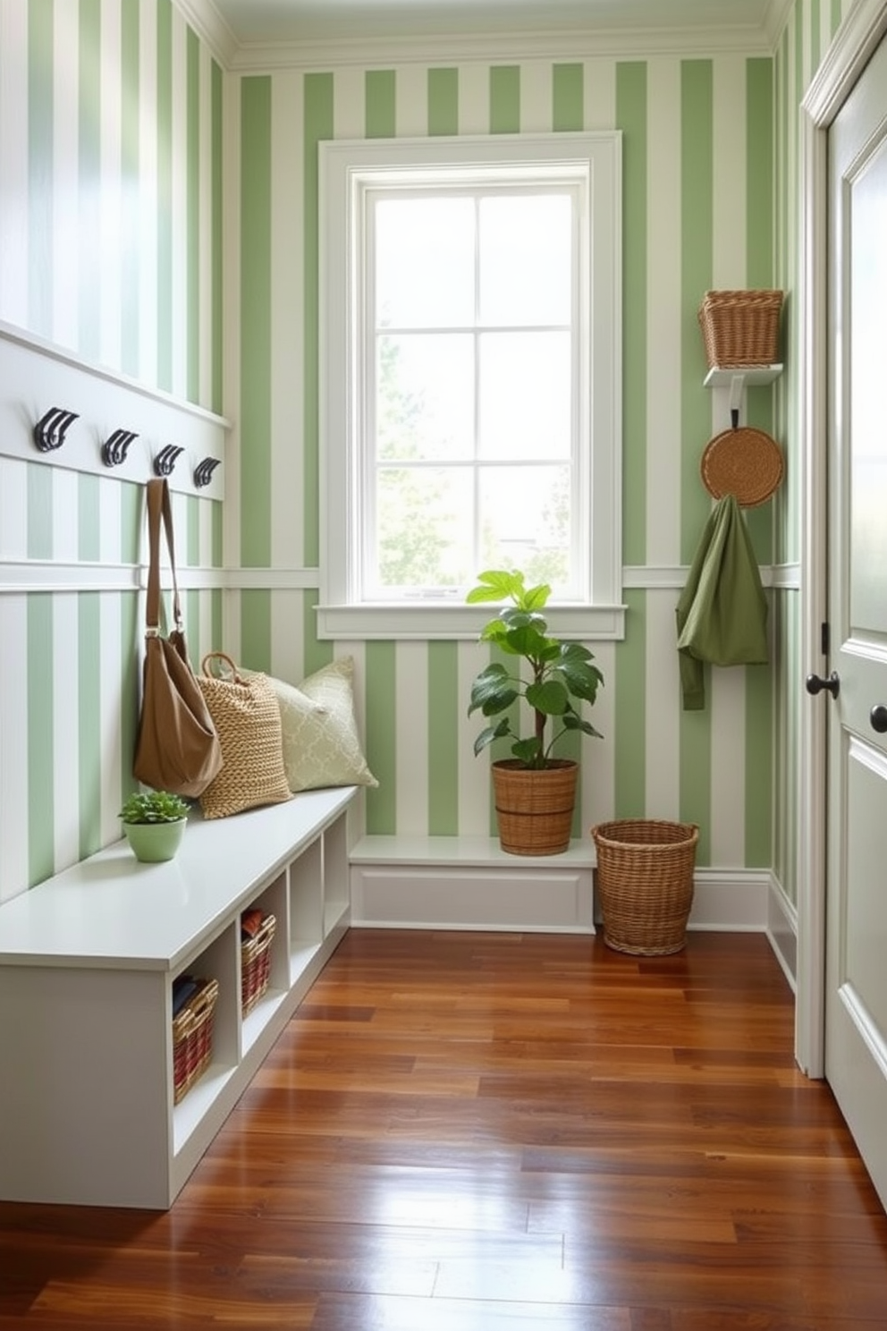 A welcoming mudroom featuring green and white striped wallpaper that creates a fresh and vibrant atmosphere. The space includes a built-in bench with storage underneath, complemented by hooks for hanging coats and bags. Natural light floods in through a large window, illuminating the polished wooden floor. Potted plants and decorative baskets add a touch of warmth and organization to the design.