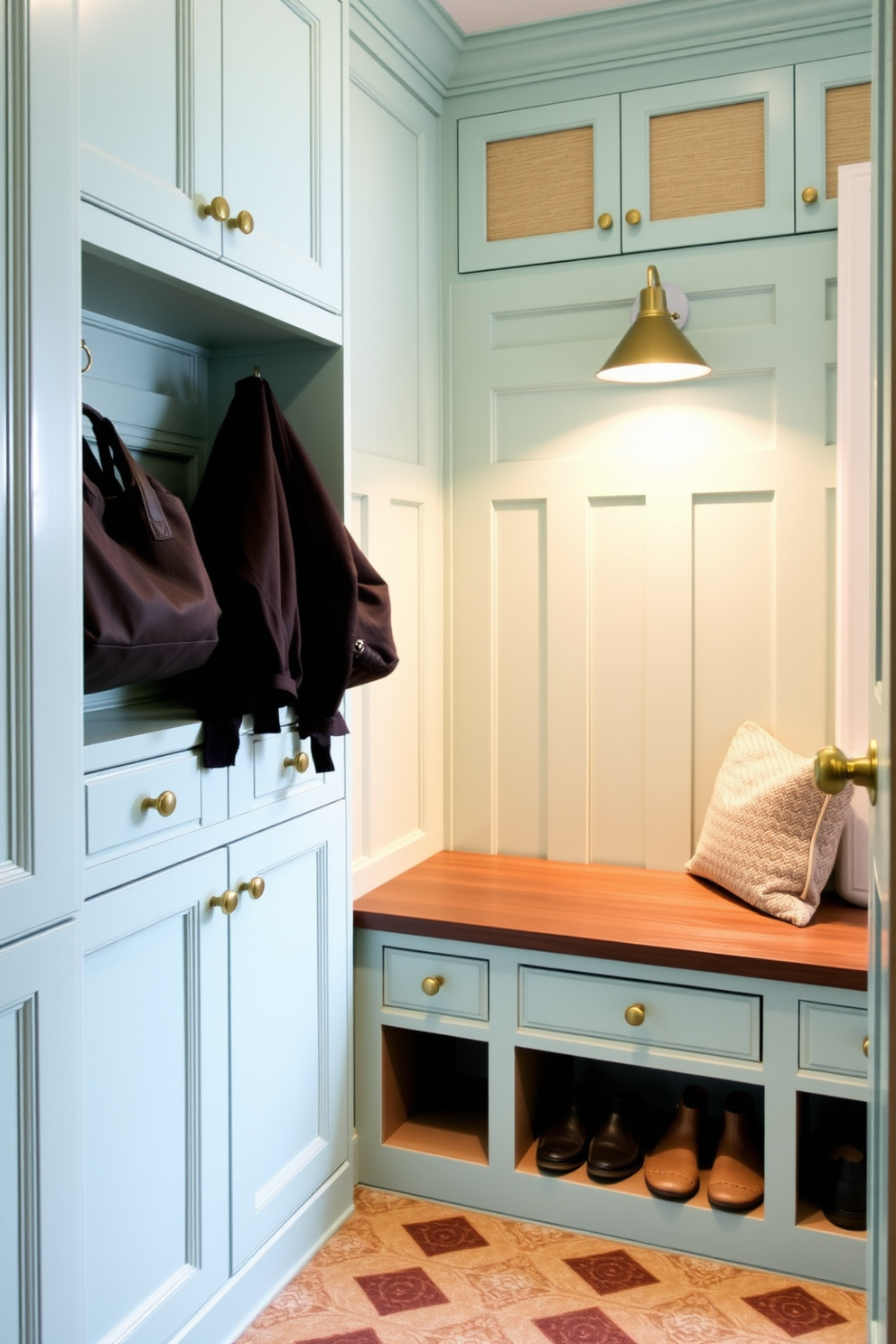 Bright mint cabinetry with brass hardware creates a fresh and inviting atmosphere in the mudroom. The space features a built-in bench with plush cushions and ample storage for shoes and bags.