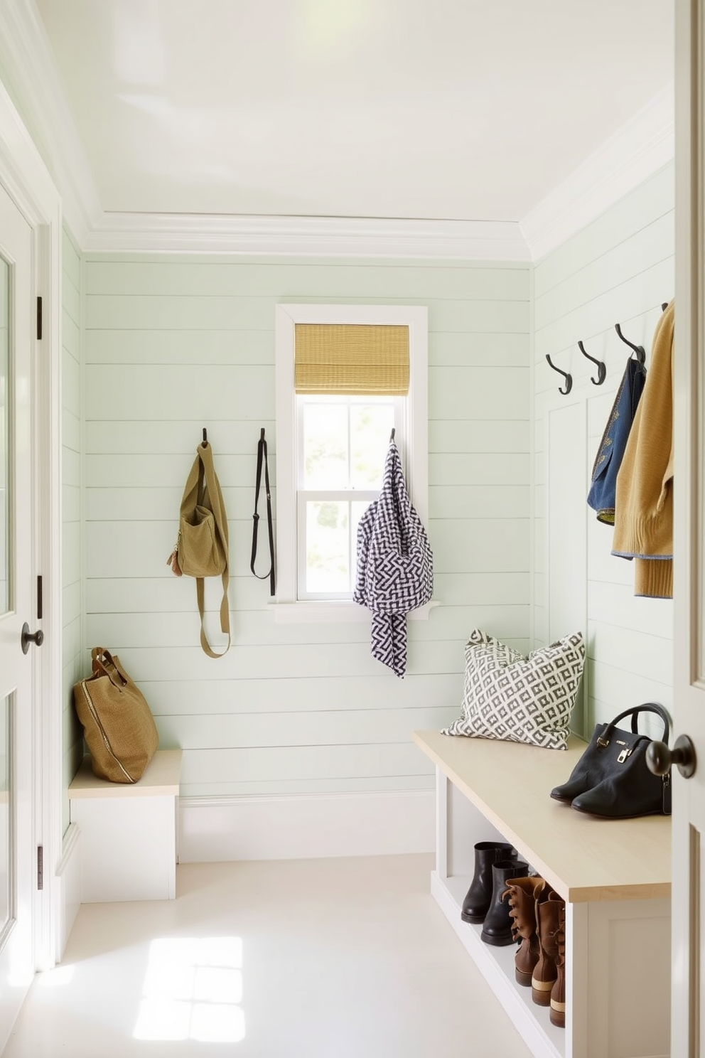 A pale green shiplap wall creates a fresh and inviting atmosphere in the mudroom. Complementing the shiplap, white trim adds a crisp contrast, enhancing the overall brightness of the space. Incorporate built-in benches with storage underneath for shoes and bags. Add hooks along the wall for coats and bags, ensuring functionality while maintaining a stylish aesthetic.