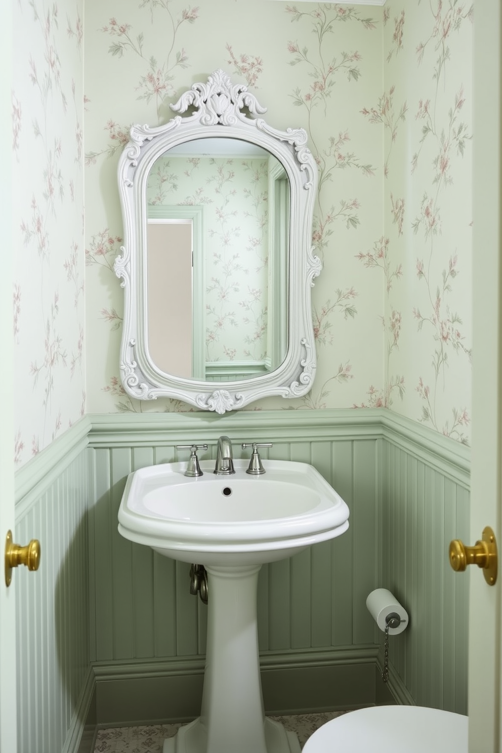 A pale green powder room features wallpaper adorned with delicate floral patterns that create a serene and inviting atmosphere. The space is enhanced by a sleek white pedestal sink and a vintage-style mirror that reflects the room's charming design.