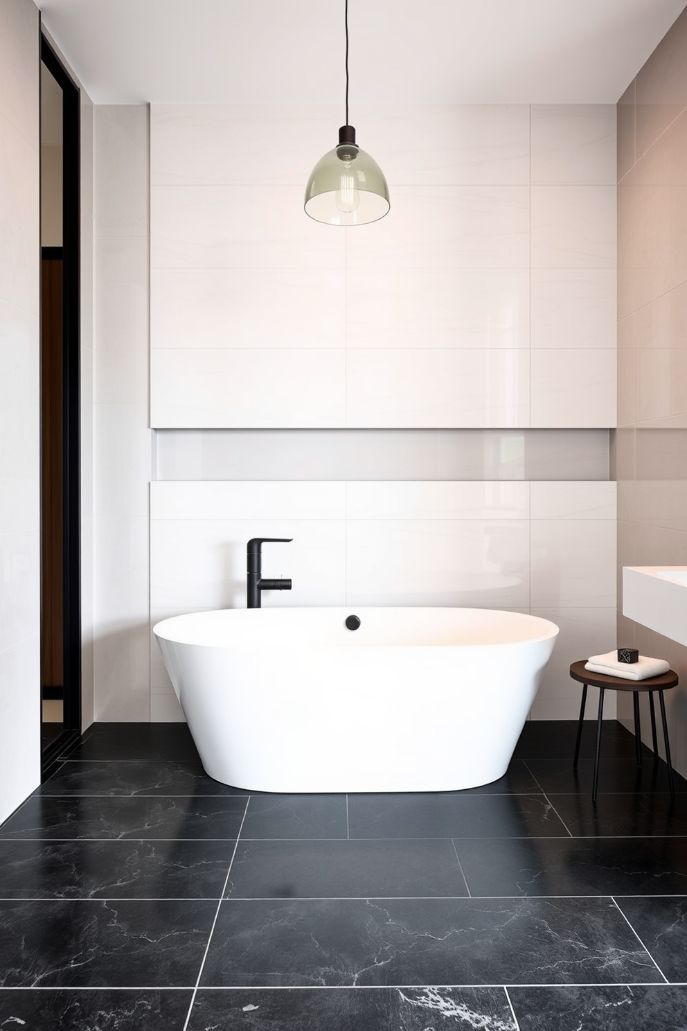 A guest bathroom featuring large format tiles that create a spacious and airy ambiance. The walls are adorned with sleek, glossy tiles in a soft neutral tone, while the floor showcases a stunning contrast with dark, textured large format tiles. A contemporary freestanding bathtub is positioned against a feature wall, complemented by a modern faucet in a matte black finish. Stylish pendant lighting hangs above, casting a warm glow over the space, enhancing the inviting atmosphere.