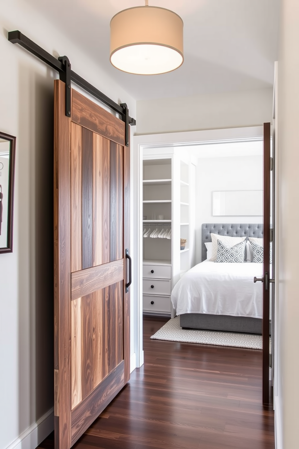 A stylish entry features sliding barn doors made of reclaimed wood that add a rustic charm. The doors slide open to reveal a bright and welcoming foyer with a modern light fixture overhead. The guest bedroom is designed with a cozy atmosphere, featuring a plush bed with layered bedding and decorative pillows. A walk-in closet is seamlessly integrated, showcasing built-in shelving and a chic dressing area with full-length mirrors.