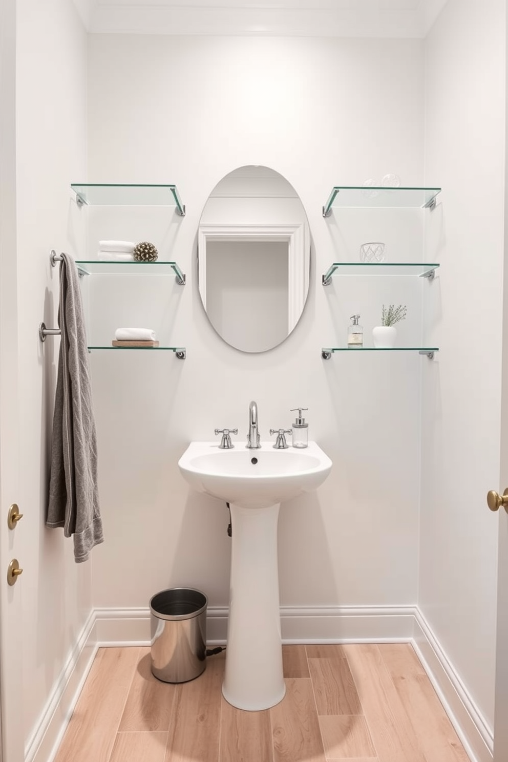 A stylish half bathroom featuring glass shelves that create a light and airy atmosphere. The walls are painted in a soft pastel hue, and the floor is adorned with light-colored wood tiles. A sleek pedestal sink is centered against the wall, complemented by a modern faucet. Decorative items are displayed on the glass shelves, adding a touch of elegance and functionality to the space.