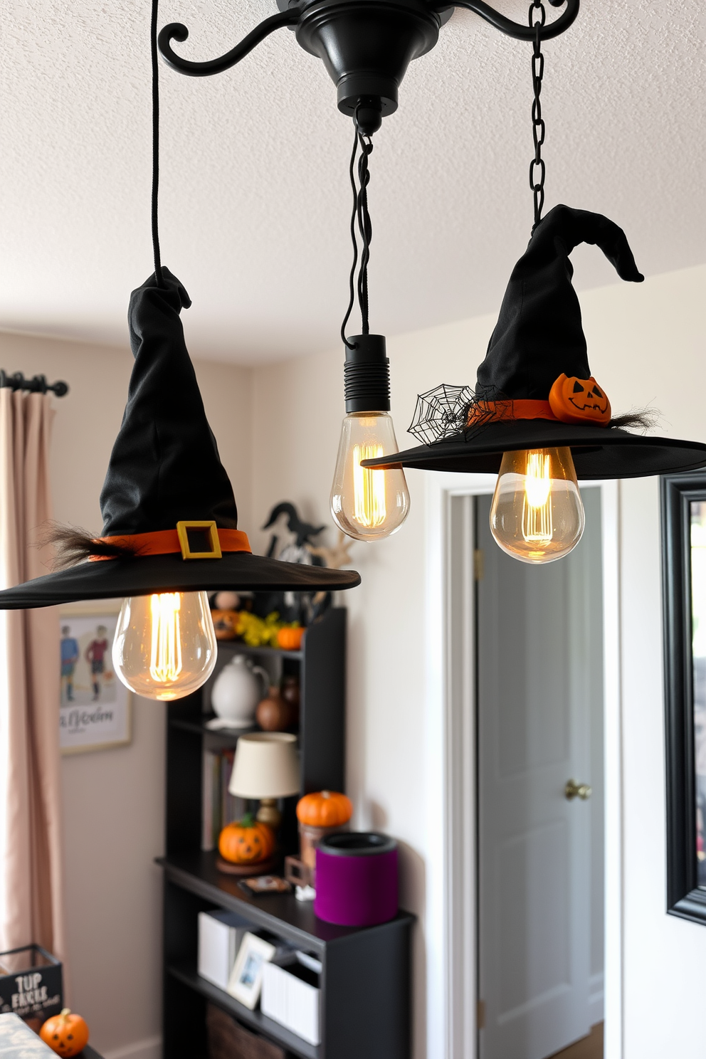 A large chalkboard is mounted on a wall, filled with colorful Halloween messages and whimsical drawings of pumpkins and ghosts. Surrounding the chalkboard, the apartment is adorned with festive decorations including spider webs, hanging bats, and orange string lights. In the living room, a cozy seating area features plush cushions in autumn colors and a coffee table decorated with mini pumpkins and candles. The dining space showcases a Halloween-themed table setting with themed plates, black napkins, and a centerpiece of eerie branches and faux cobwebs.