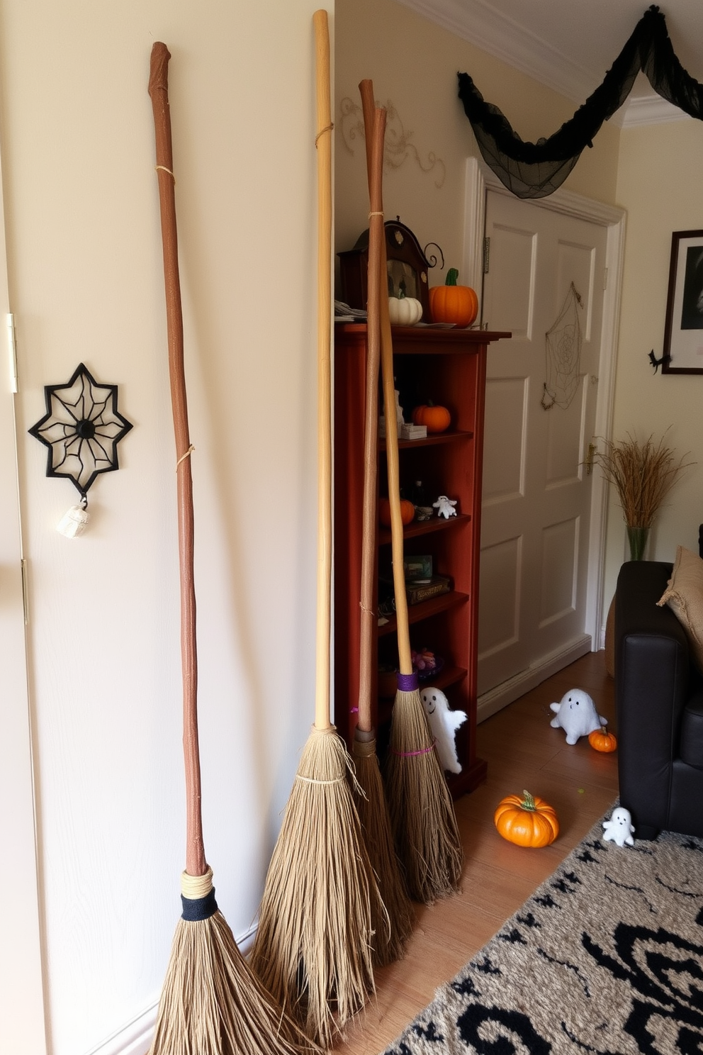 Broomsticks are leaning against the walls of a cozy apartment, creating a whimsical Halloween atmosphere. The space is adorned with playful decorations like cobwebs, small pumpkins, and ghostly figures, enhancing the festive spirit.