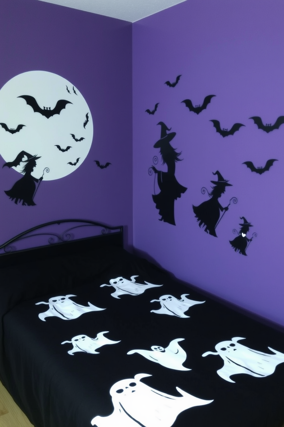 A whimsical Halloween bedroom featuring wall decals of bats and spiders adorning the walls. The bed is dressed in dark purple linens, and a plush black throw blanket is casually draped across the foot of the bed.