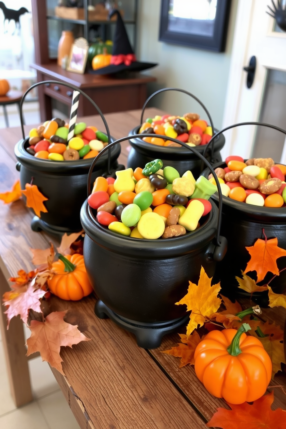 A charming Halloween display featuring decorative cauldrons filled with an assortment of colorful treats. The cauldrons are placed on a rustic wooden table adorned with autumn leaves and small pumpkins.