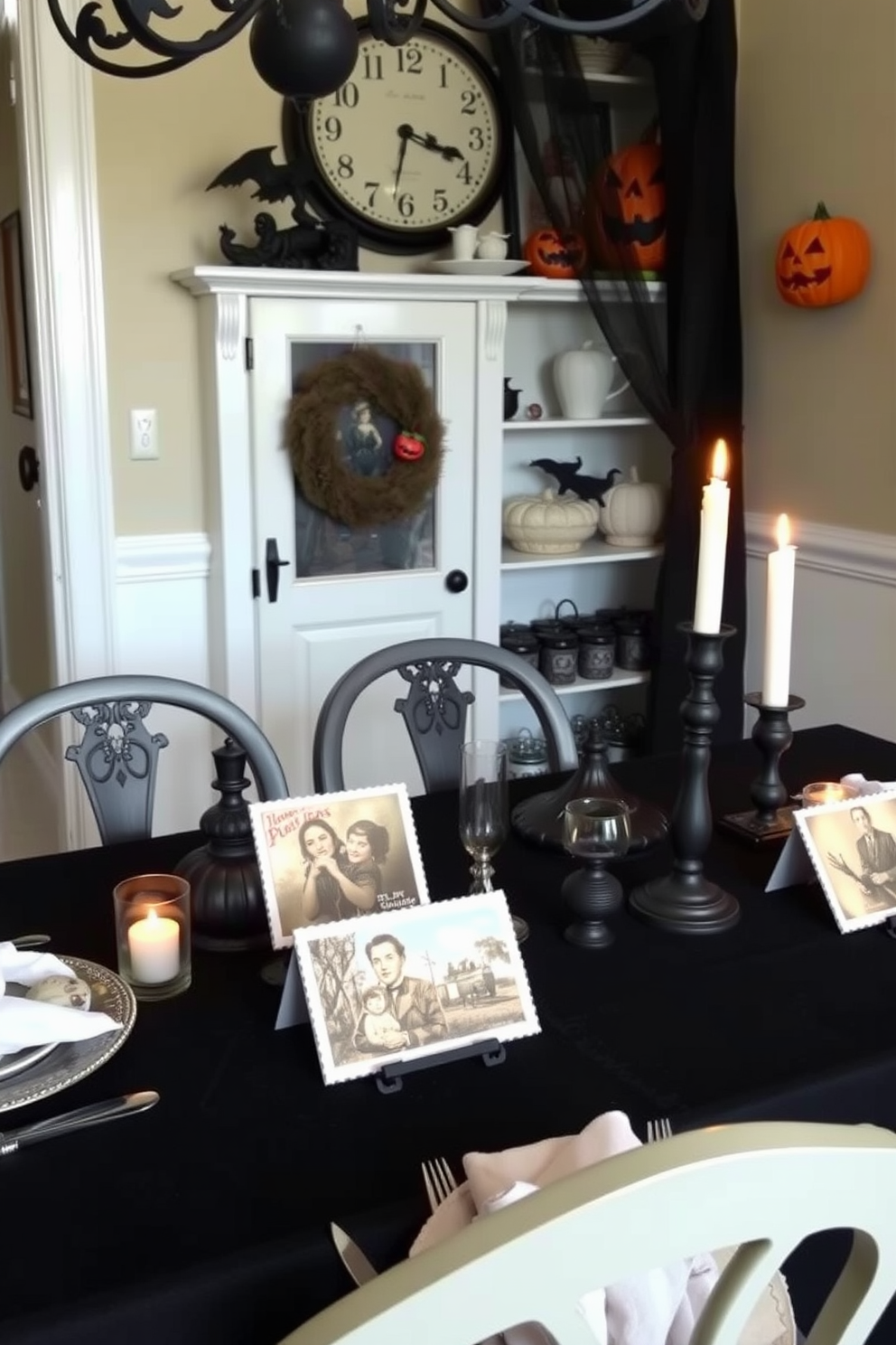 A charming Halloween dining room setting featuring vintage postcards as table decor. The table is elegantly set with a black tablecloth, and the postcards are arranged artfully alongside flickering candle holders.