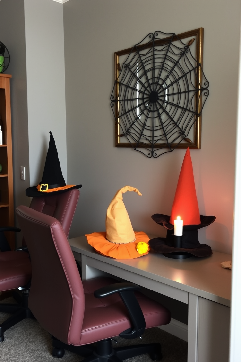 A cozy home office decorated for Halloween features office chairs adorned with whimsical witch hats in various colors. The walls are painted a warm gray, and a small pumpkin sits on the desk alongside a flickering candle.