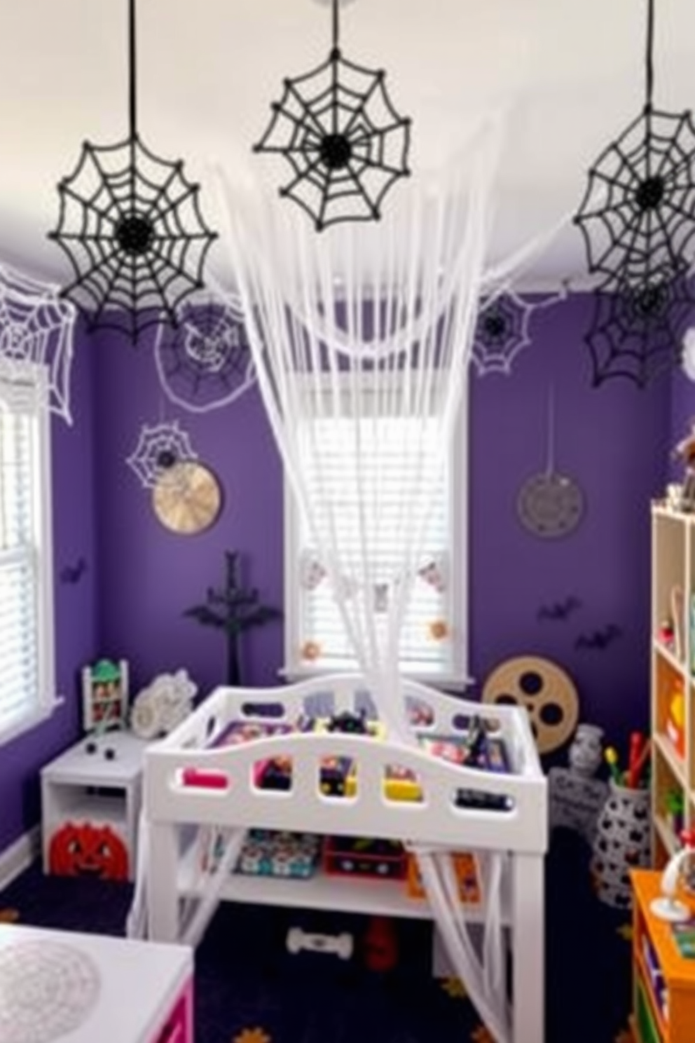 A whimsical Halloween playroom decorated with spooky spider web ceiling hangings. The walls are painted in a deep purple hue, and colorful Halloween-themed decorations are scattered throughout the room.