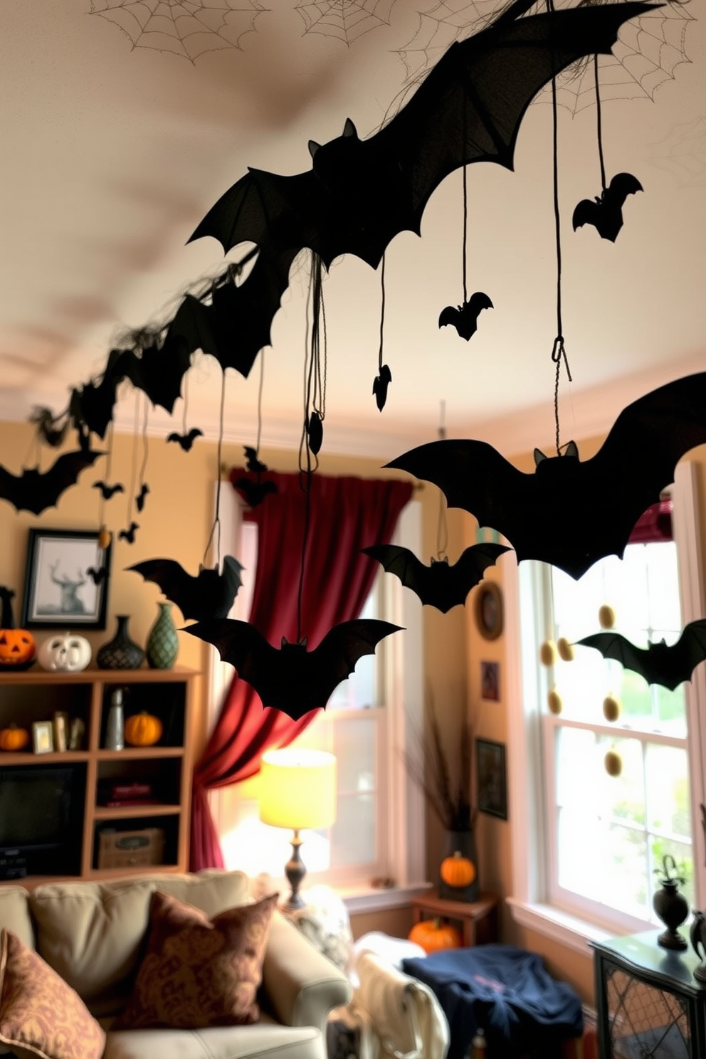 A cozy small living room adorned with Halloween decorations. Hanging bats dangle from the ceiling, creating a spooky atmosphere while complementing the warm lighting.