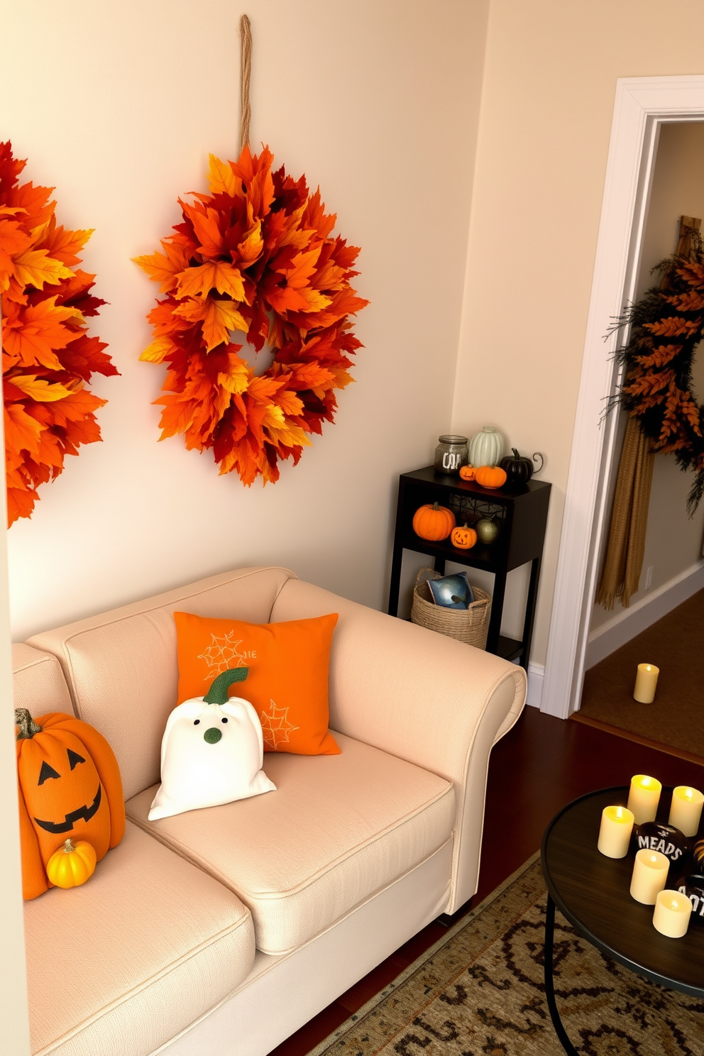 A seasonal wreath made of autumn leaves and pumpkins adorns the front door, creating a warm and inviting entrance. The wreath features vibrant orange and deep red hues, complemented by small decorative gourds attached to its base. Inside, the small living room is decorated with cozy elements for Halloween. Plush throw pillows in pumpkin and ghost designs are scattered across a soft beige sofa, while a small table displays a collection of miniature jack-o'-lanterns and flickering candles.