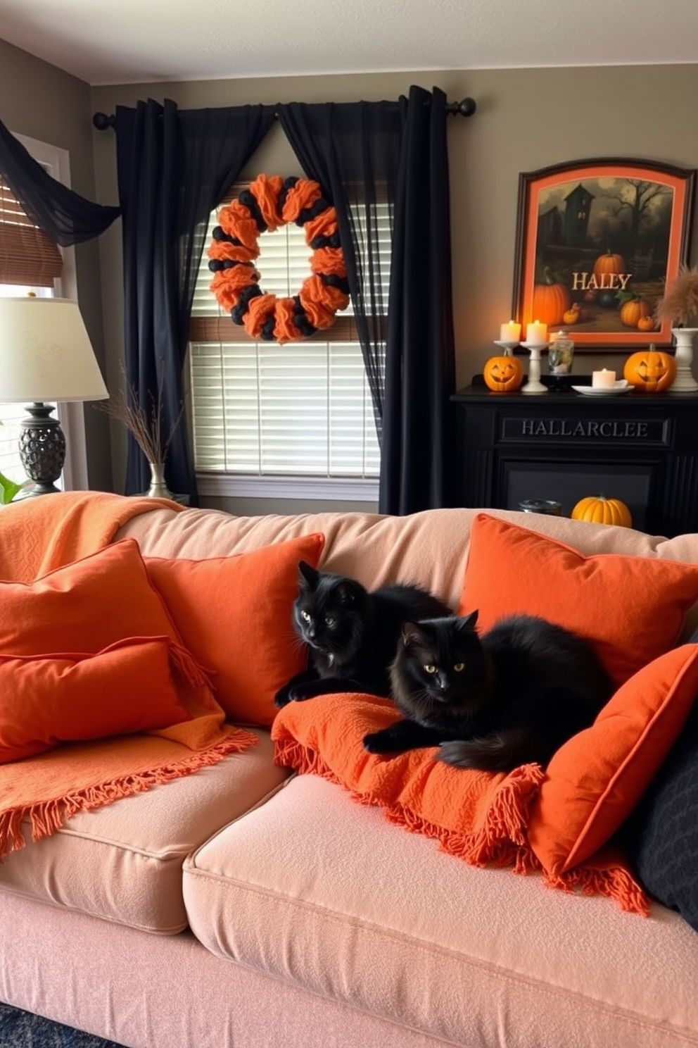 A cozy living room adorned for Halloween features a plush sofa draped with soft blankets and decorated with vibrant orange and black cushions. Two fluffy black cats lounge comfortably on the sofa, adding a playful touch to the festive atmosphere.