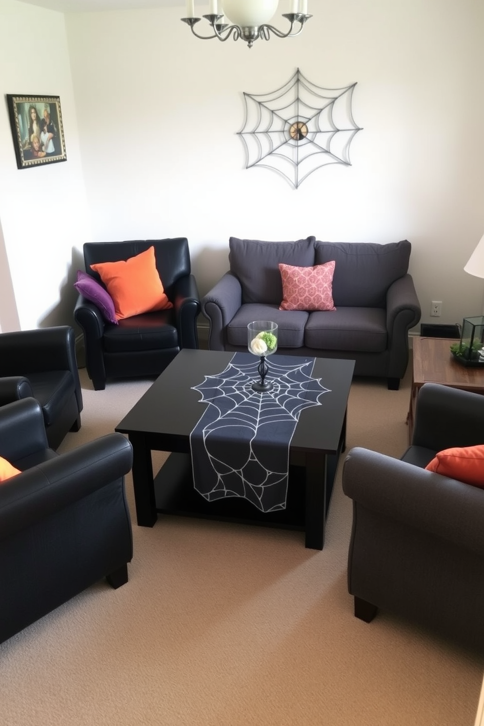 A small living room features a spiderweb table runner elegantly draped over a dark wooden coffee table. Surrounding the table are plush black armchairs and a cozy gray sofa adorned with orange and purple throw pillows for a festive Halloween touch.